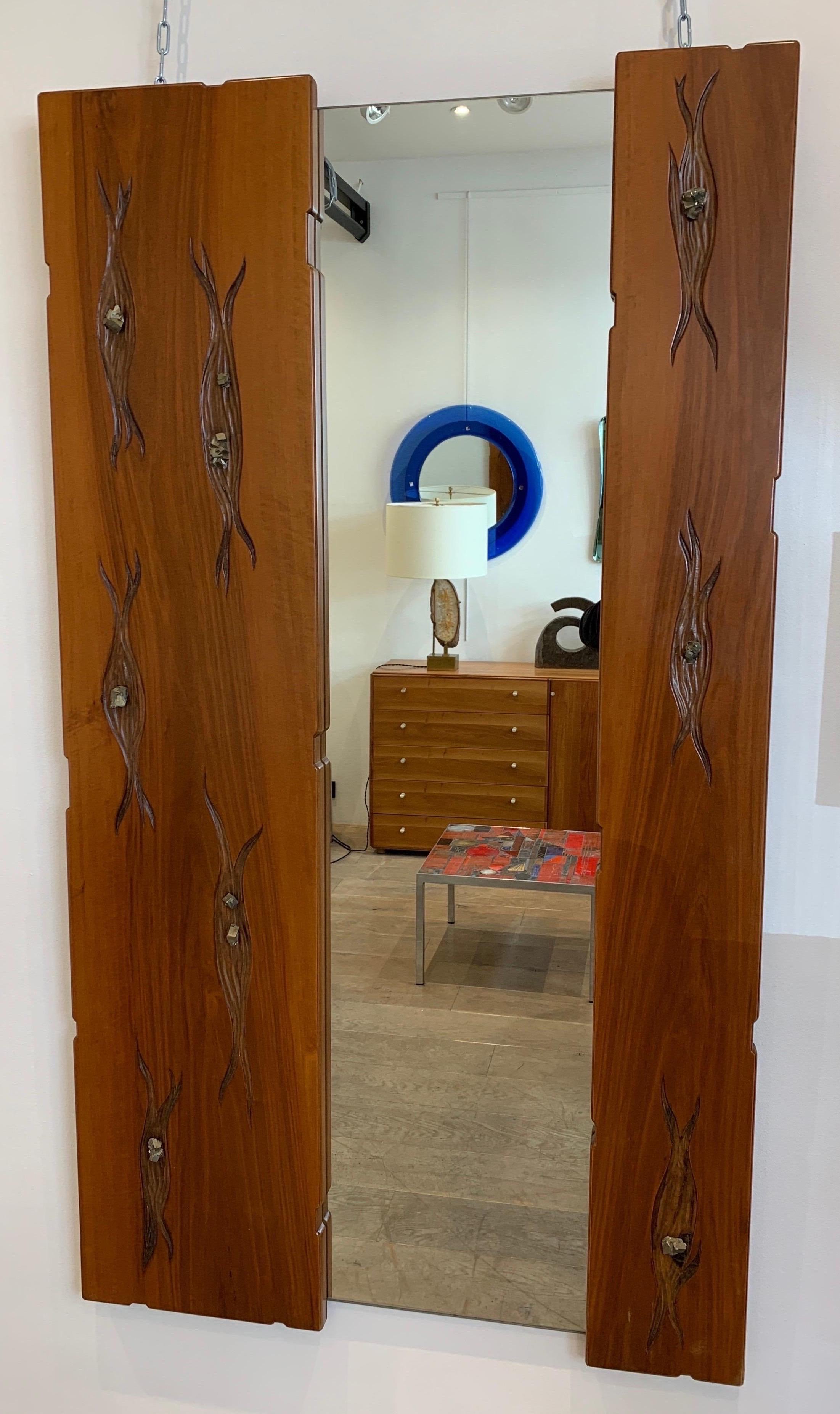 The mirror was executed by the Italian Designer Luca Roncalli, probably in the late 1960s early 1970s. The piece is made of solid walnut that was hand carved with abstract pattern into which Pyrite stones are set.
The mirror is full length. It