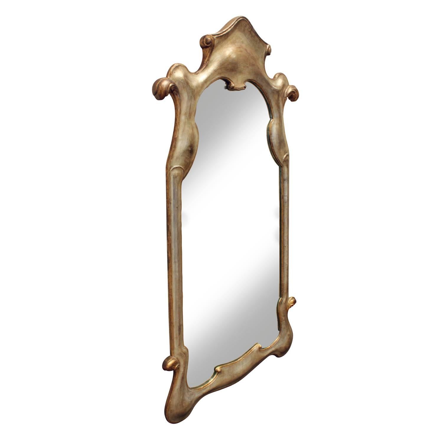 Wall hanging mirror in plaster with pale gold lacquer finish, Italian, 1940s. The form and coloration of this mirror are really beautiful.