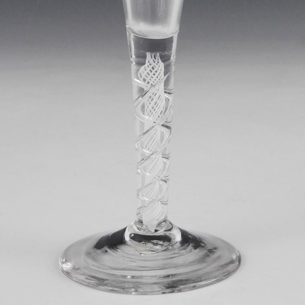 Heading : Elegant mixed twist Georgian ratafia glass
Period : George II / George III - c1760
Origin : England
Colour : Clear
Bowl : Conical
Stem : A pair of air threads outwith an opaque spiral gauze
Foot : Conical
Pontil : Snapped
Glass Type :