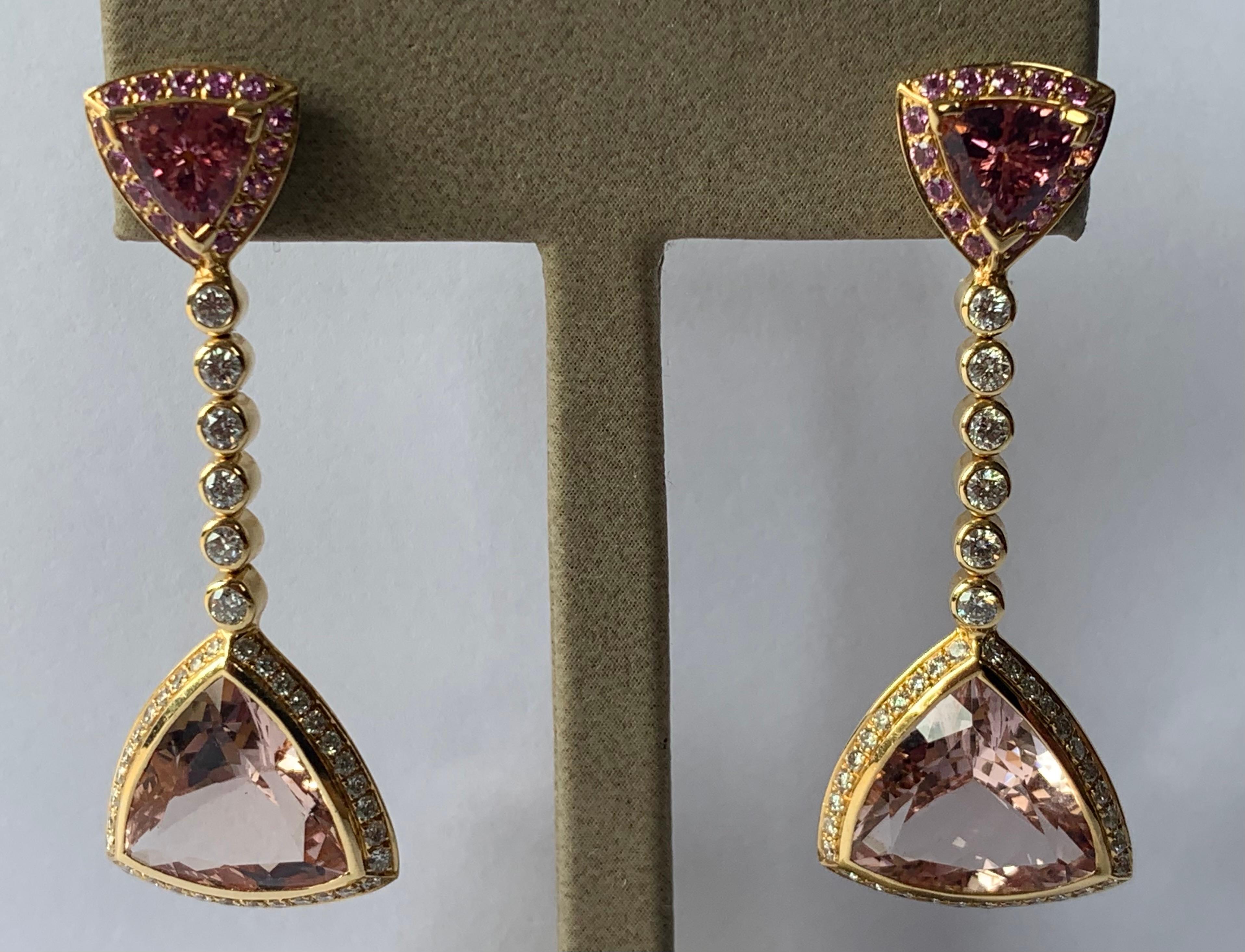 A pair of elegant 18 K yellow Gold earrings signed by Gübelin Lucerne set with 2 triangle shaped pink Tourmalines weighing 1.97 ct, 2 triangle shaped Morganites (pink variety of Beryl) weighing 11.84 ct and Diamonds weighing 1.21 ct, G color, vs