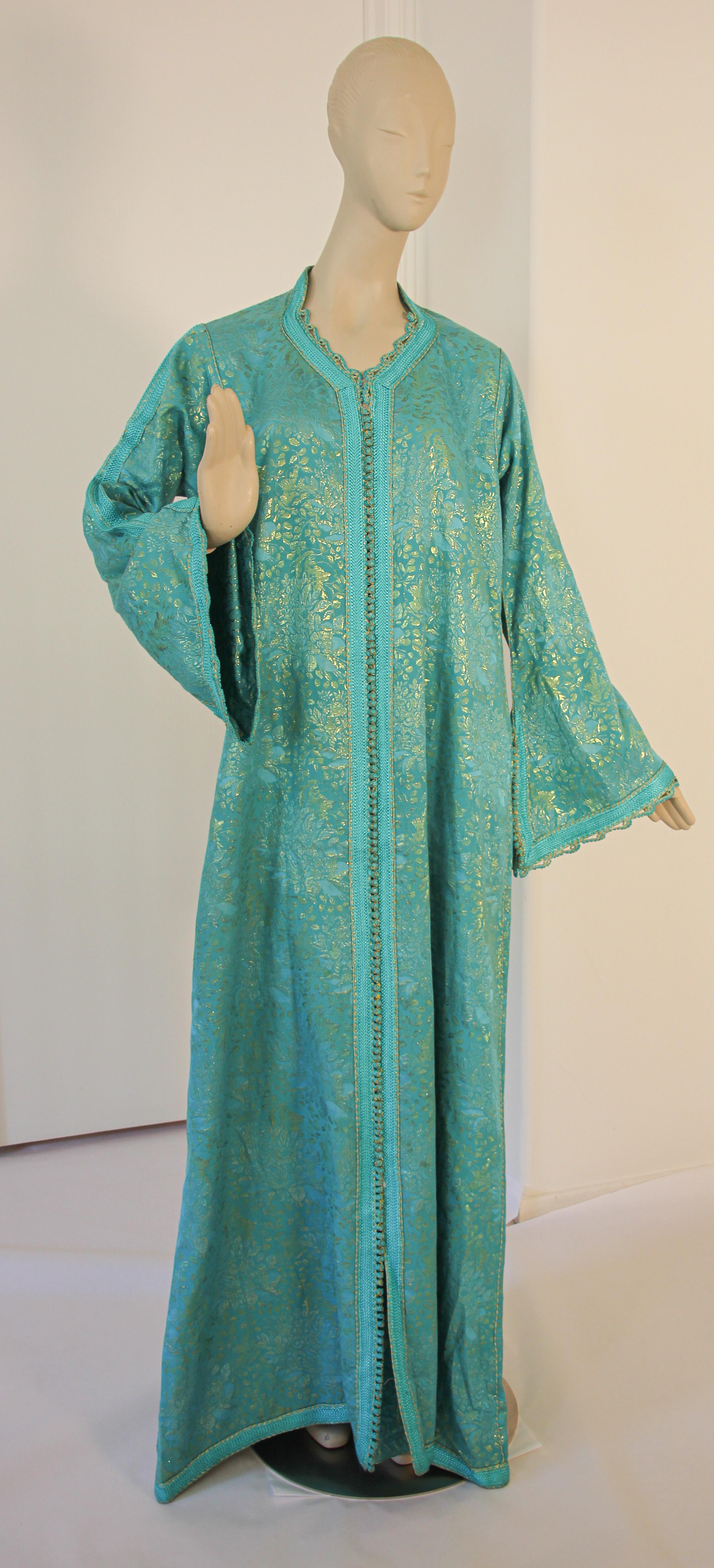Stunning and elegant Moroccan caftan with metallic blue silk brocade.
handmade in Morocco and tailored for a relaxed fit with wide sleeves
This long maxi dress kaftan is embroidered and embellished entirely by hand.
The kaftan features a traditional