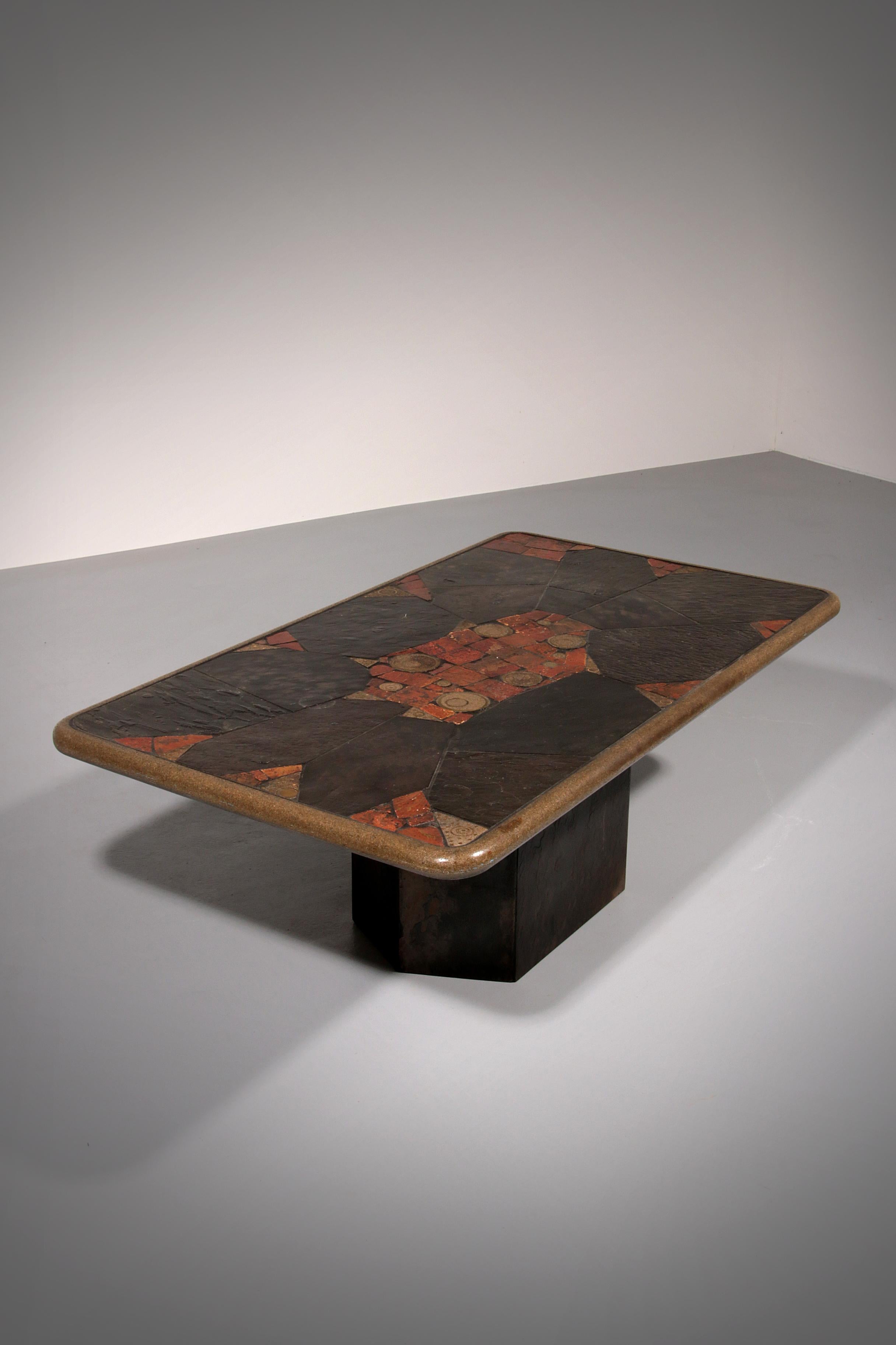 This stunning hexagonal stone coffee table, inspired by the iconic style of Paul Kingma, features a beautifully hand-laid mosaic of natural stone inlays and refined brass accents. The unique hexagon-shaped stone base provides both visual interest