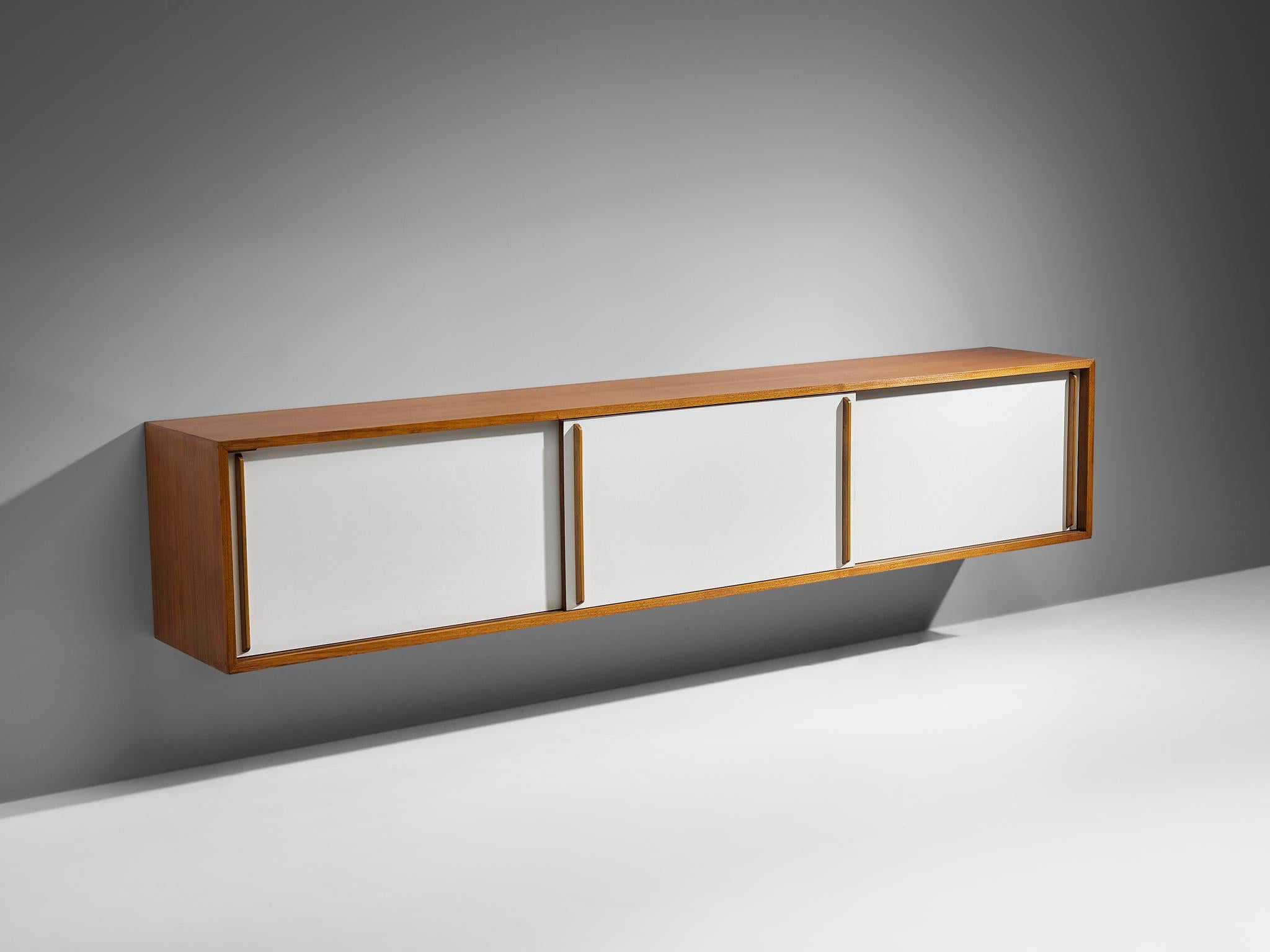Sideboard, teak, lacquered wood, Europe, 1960s. 

Elegant mounted sideboard made in teak and lacquered wood. This sideboard appears very sleek and sober but notice the nice detailing of the teak handles that stand out against the light colored