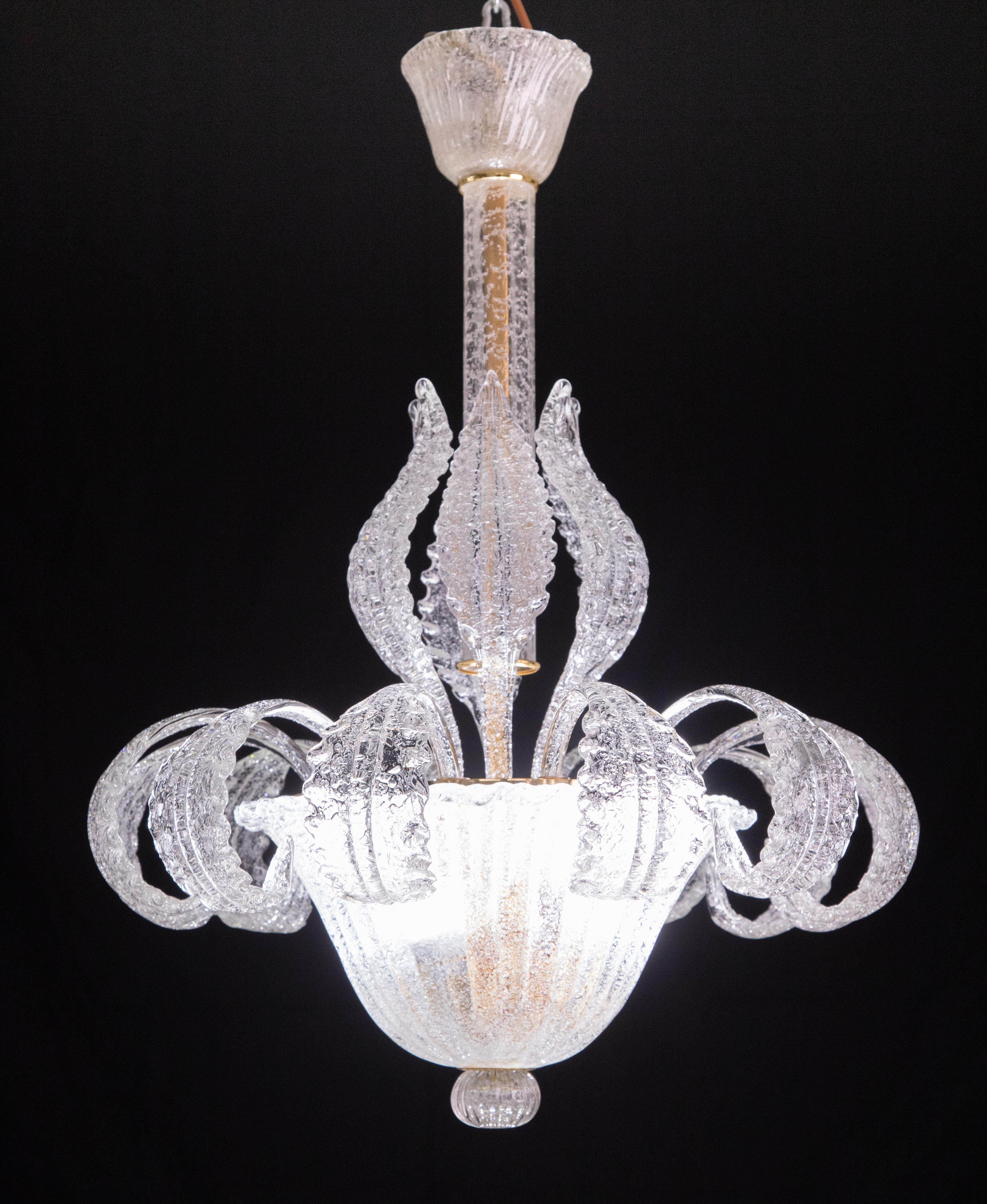 Elegant Murano chandelier composed externally of only glass elements.

The chandelier consists of a rosette, a trunk and a massive central disk, all decorated with 12 beautiful leaves plus 6 tall ones.

The height measures 80 centimeters, the