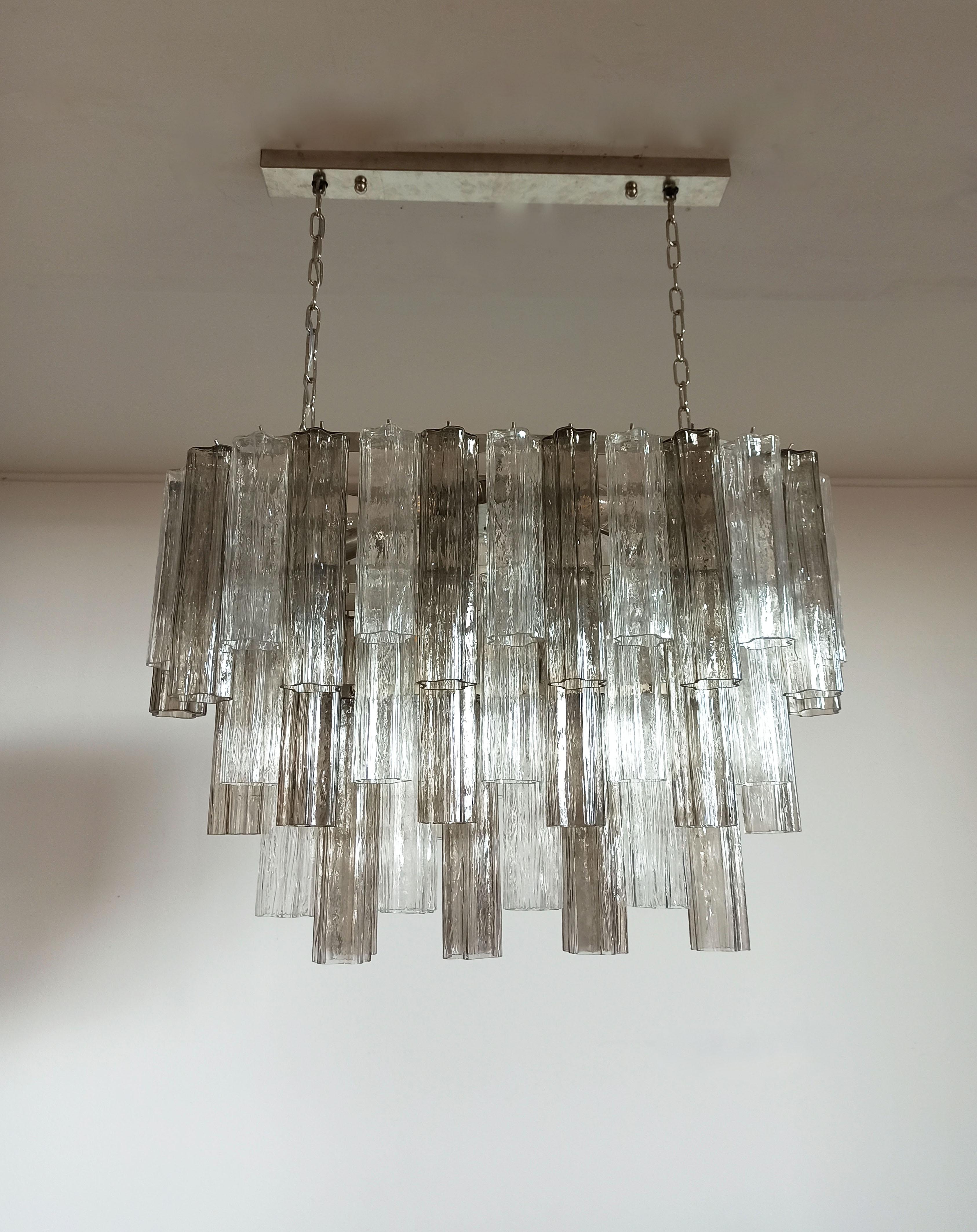 Elegant Italian chandelier made from 62 beautiful Murano transparent and smoked glass tubes. The armor polished nickel supports 62 large shaded multicolored glass tubes in a star shape, which makes the chandelier a true work of art.
Period: