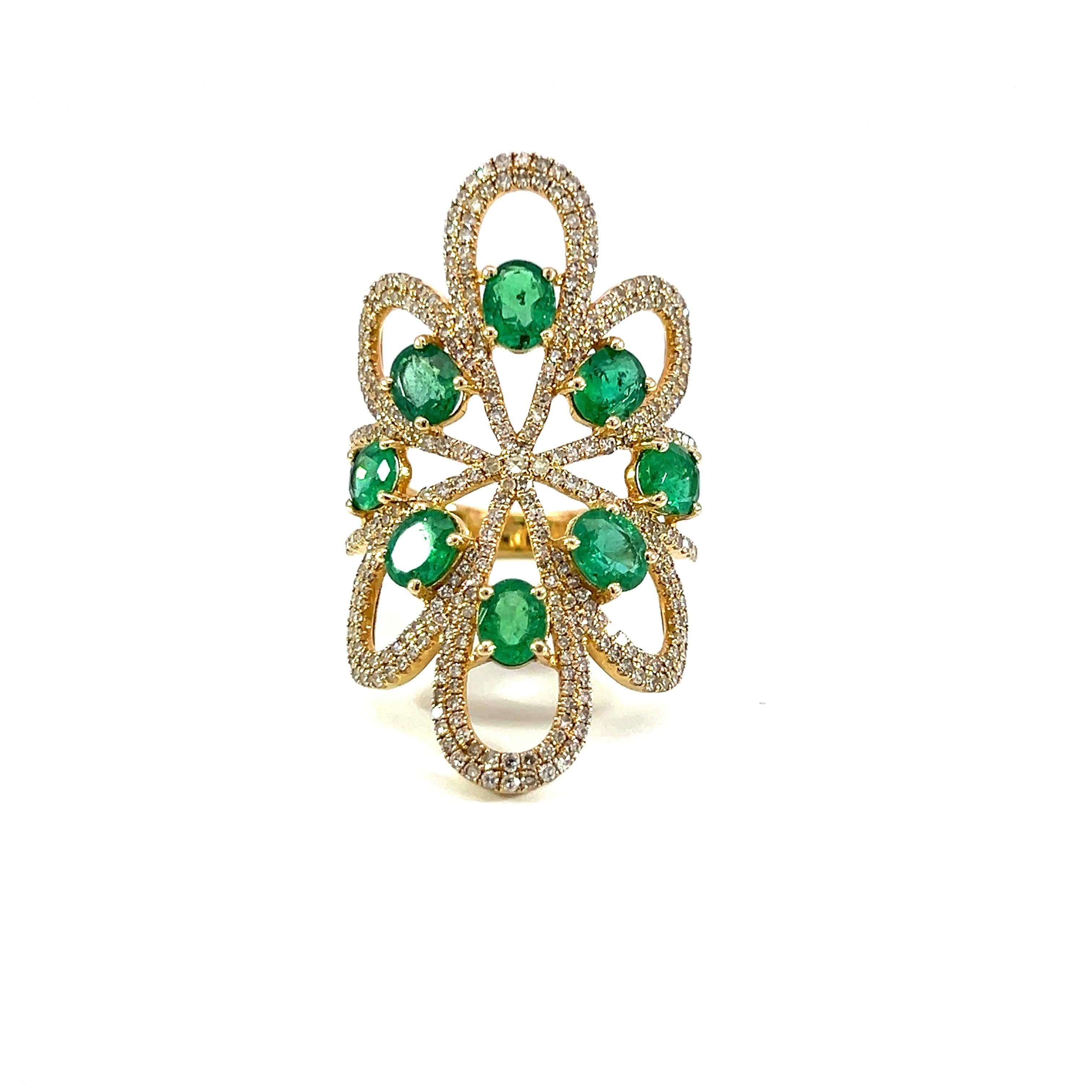 This exquisite ring features a stunning arrangement of vibrant 2.37-carat emeralds set in a delicate 14kt yellow gold band. The intricate design is accentuated with 1.11-carat sparkling diamonds, making it the perfect statement piece for any