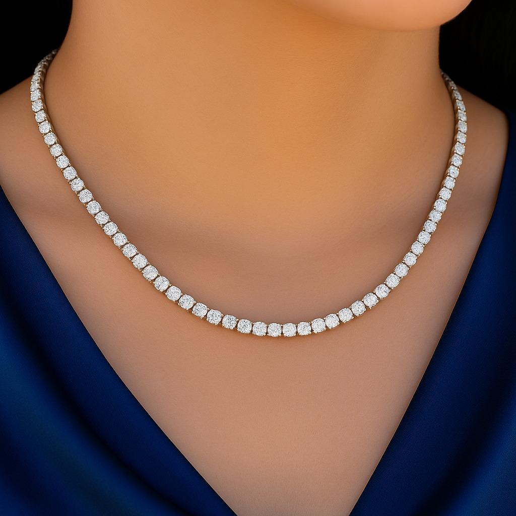 This stunning natural diamond tennis necklace features a continuous line of sparkling diamonds, perfectly set to catch the light from every angle. 
All 124 Diamonds are natural; weighing approximately 10pts each. Set in a 17