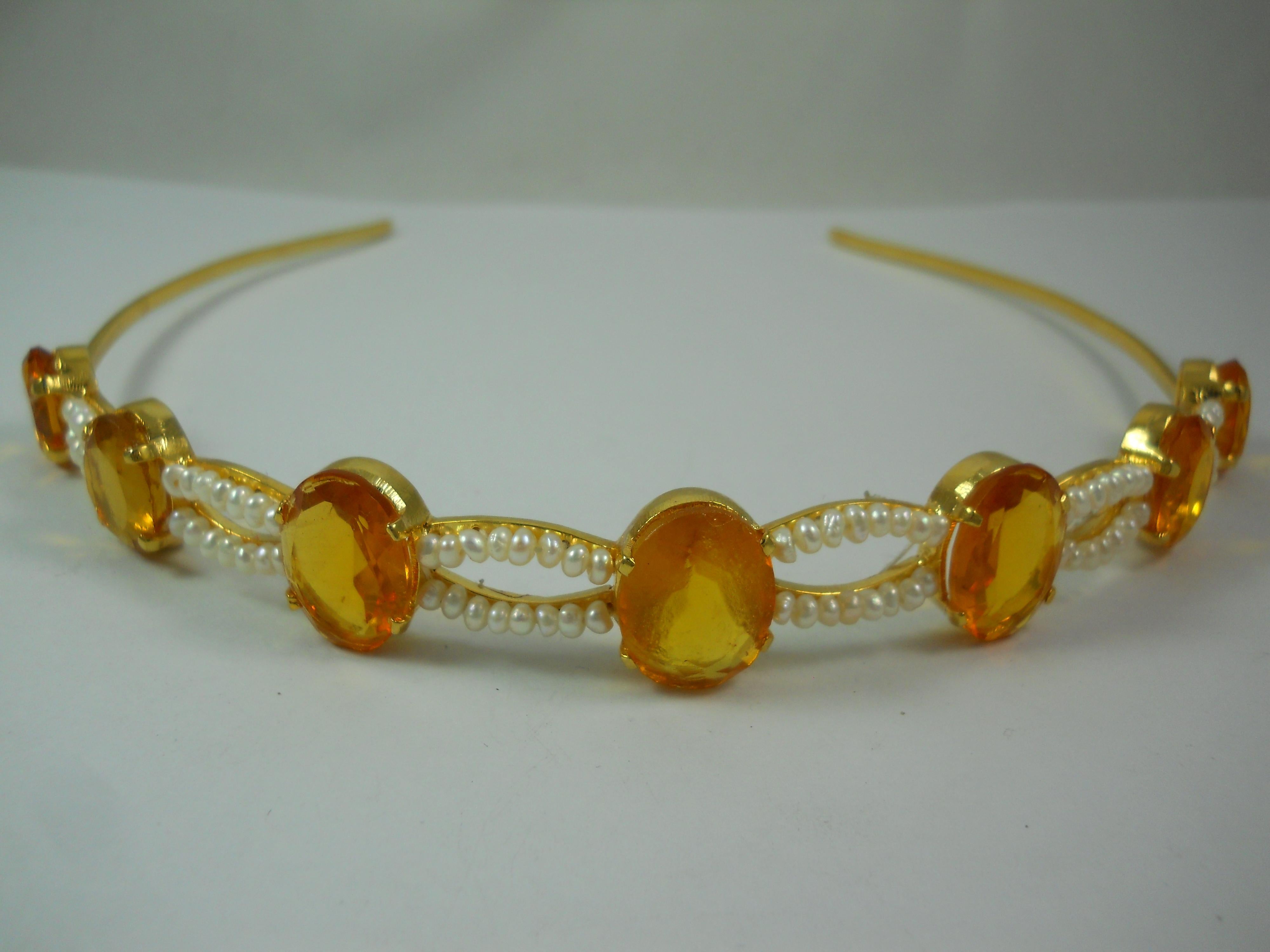 For the queen in you!
This stunning tiara is a symbol of beauty and self-love. It is handmade with Natural pearls and citrine in sterling silver with yellow gold plating. 

Gemstone type- Citrine
Gemstone origin- Natural 

Pearl- Fresh water