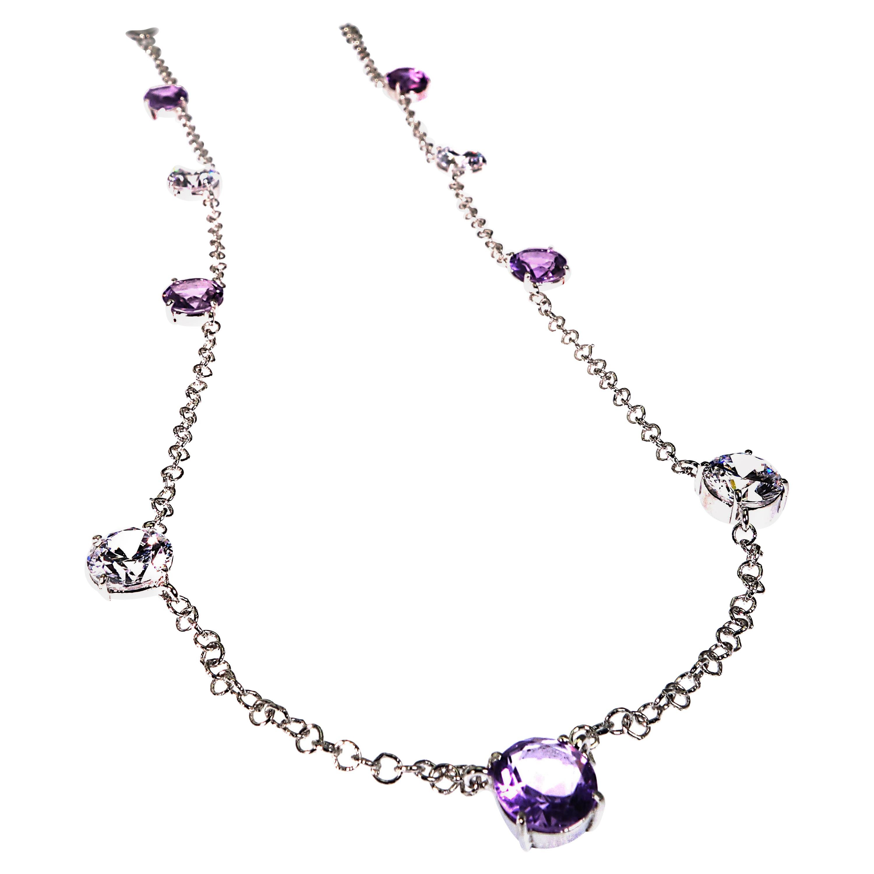 Unique necklace of 5 stations of 8 MM Amethyst alternating with 4 stations of 8 MM Sparkling White genuine Zircons.  The 14K white gold rhodium plated Sterling Silver chain upon which they are mounted is just the right amount of silver to enhance