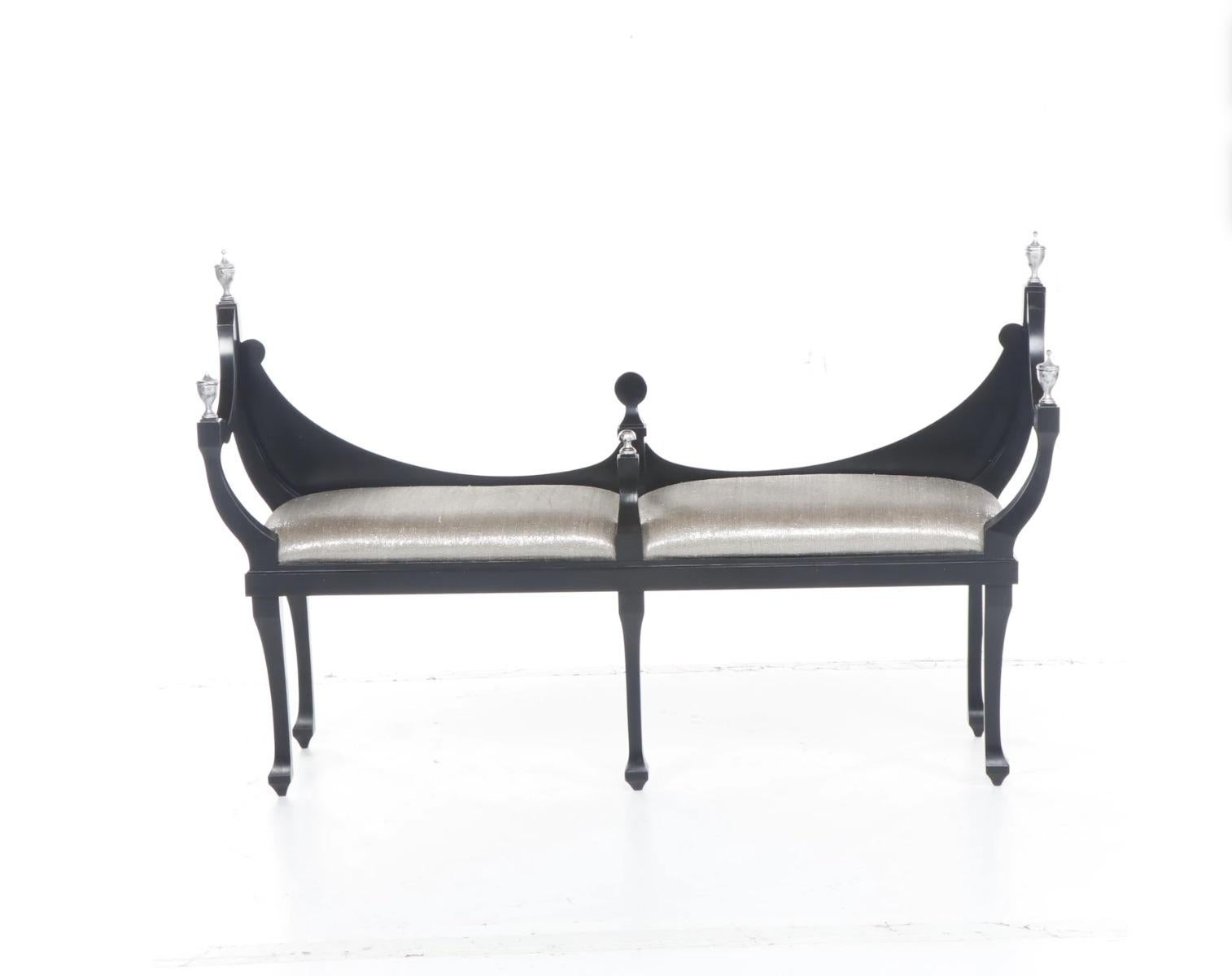 Unique Elegant Neoclassical Modern Black Wood Lacquered Bench/Settee with Gleaming Silver Leaf Finials & Silver Lame Fabric Upholstery. 
The wood bench is painted in a smooth satin lacquer lustrous finish. The upholstery fabric has a silver