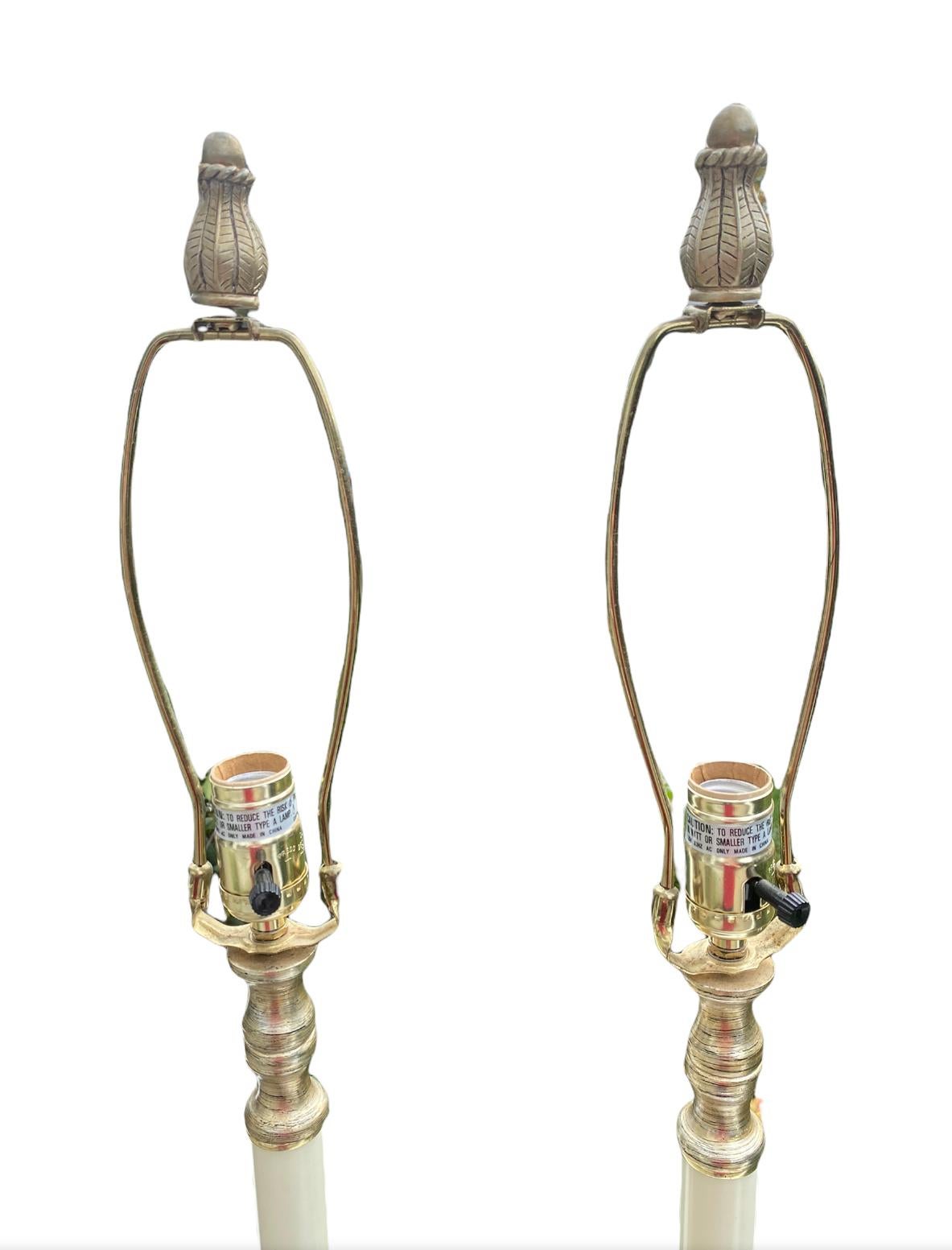 Handsome pair of tall table lamps in Tuscan style. Ornate silhouette with shallow trays. Accommodate all modern style bulbs. In good working order.