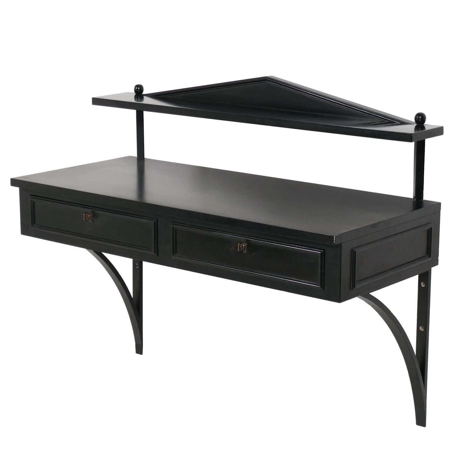 Elegant neoclassical wall mounted console table or bar, designed by Ronnie Brahms for H. Sacks, American, circa 1950s. This piece is a versatile size and would work well as a wall mounted console in an entryway or as a dry bar. It features two deep