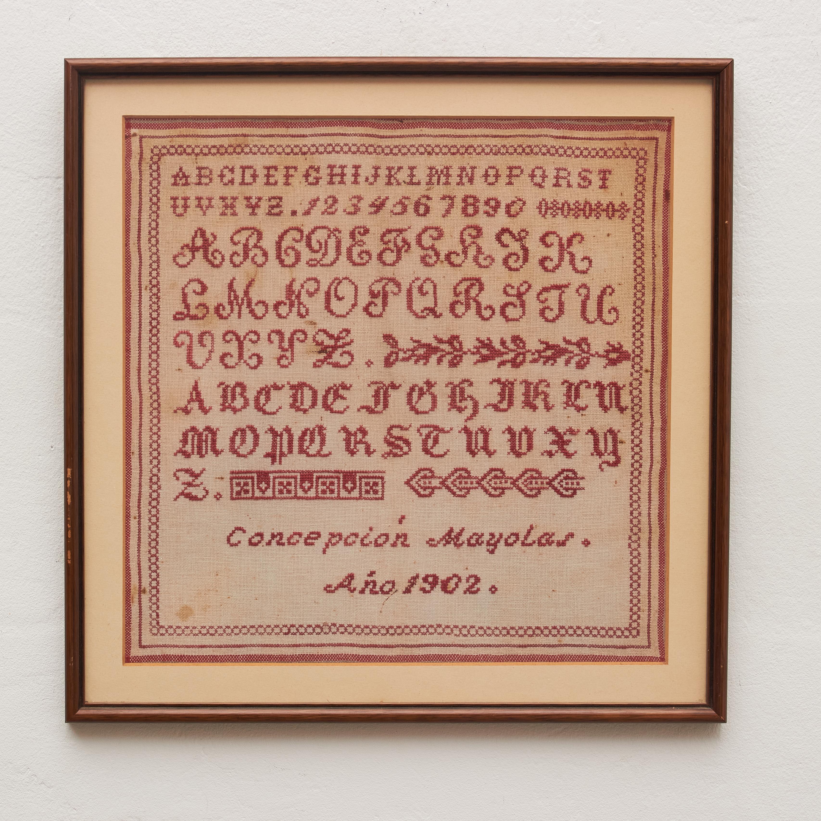 Transport yourself to a bygone era with our vintage cross-stitch sampler from the early 20th century. This timeless piece features a classic red-on-white design adorned with meticulously crafted alphabet letters, numbers, and an enchanting border