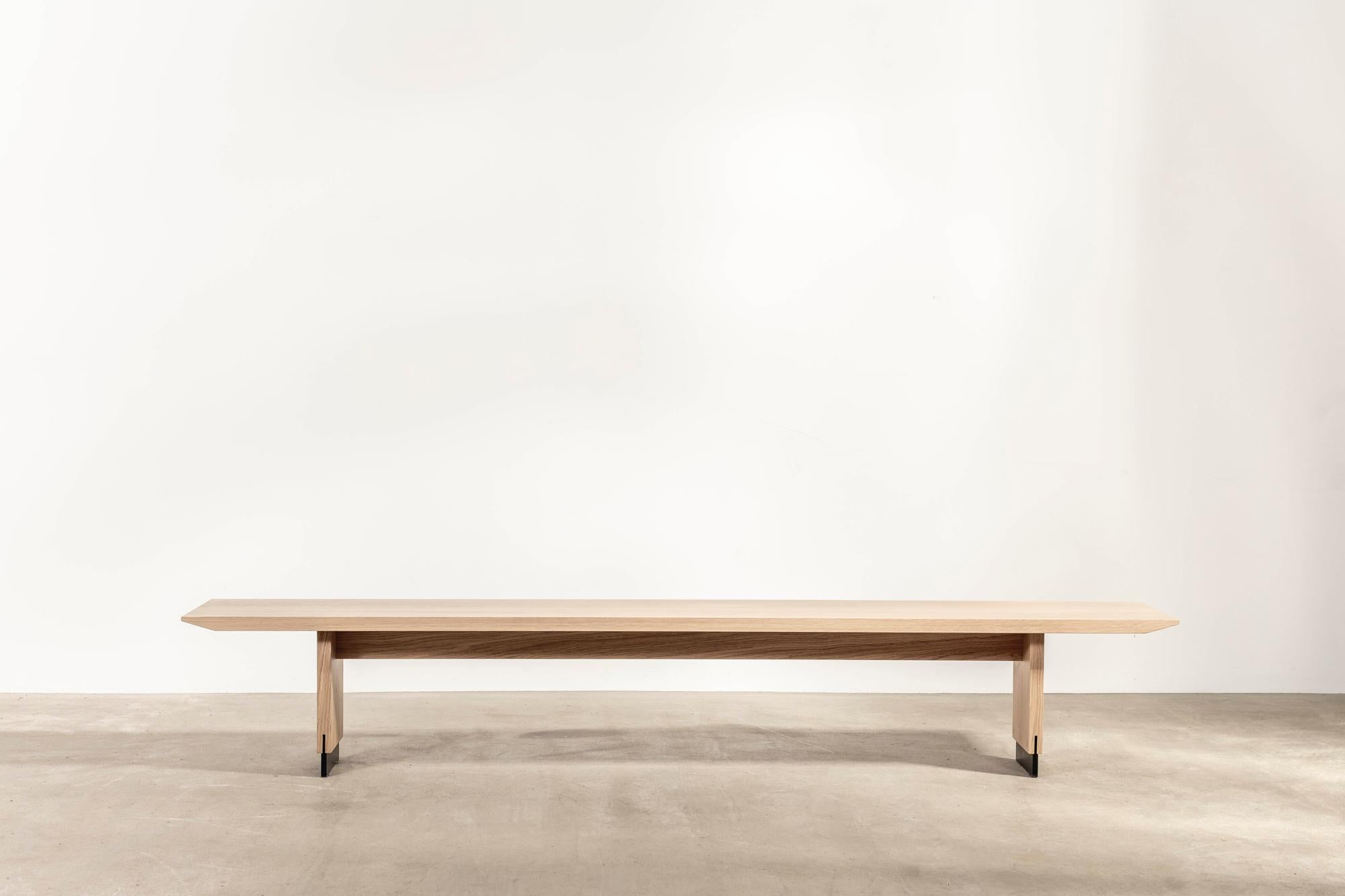 Designed and made for a revered Parisian boutique, the 'Otto' bench sits slightly low, with ample space for three people.

Its solid oak seat comes to a gentle taper at its edges, while inset patinated brass feet elegantly lift the piece.

The