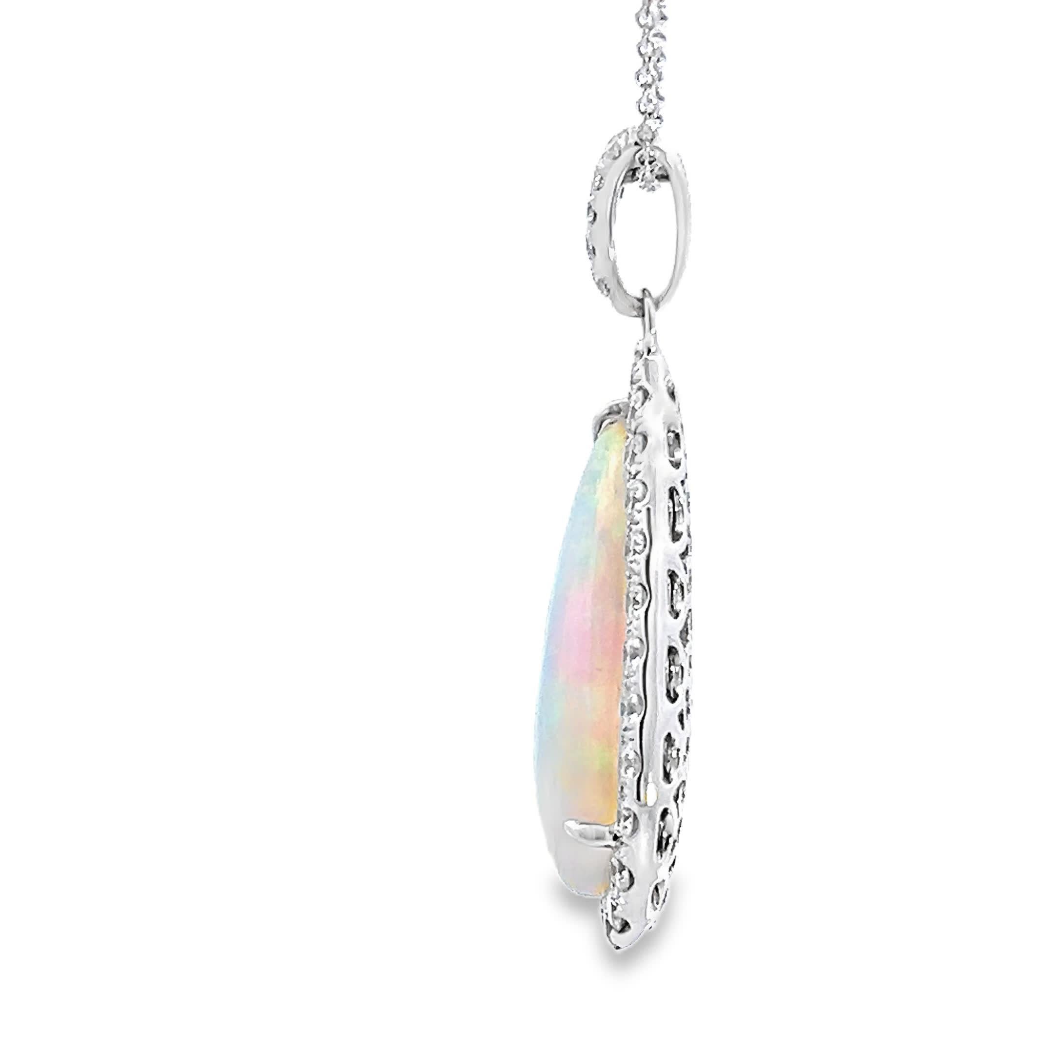 This stunning opal pendant captures the essence of elegance with its unique teardrop shape and vibrant play of colors. Surrounded by a halo of sparkling diamonds, it adds a touch of luxury to any outfit. Perfect for special occasions or as a