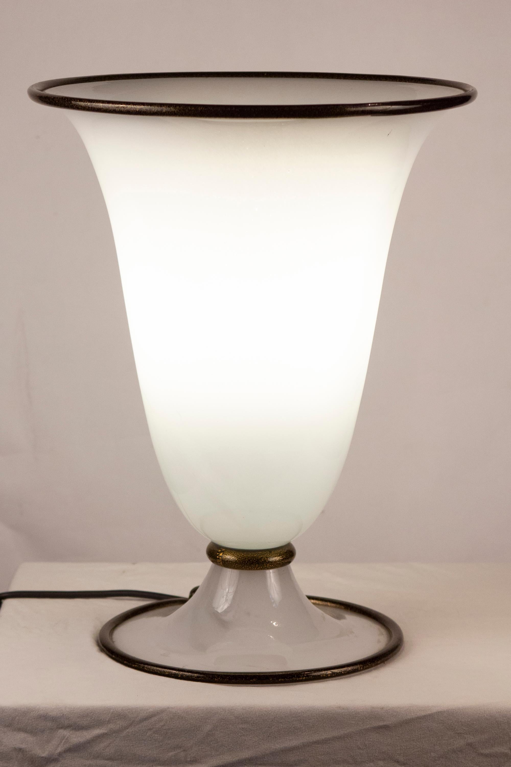 Elegant opaline Murano glass Table Lamp , contoured by  black  decoration with gold intrusion .
 by Barovier & Toso Primavera Model 6211  1980' with original label .
 
 Perfect Vintage condition . 
1 E27 light bulb 40W
 
