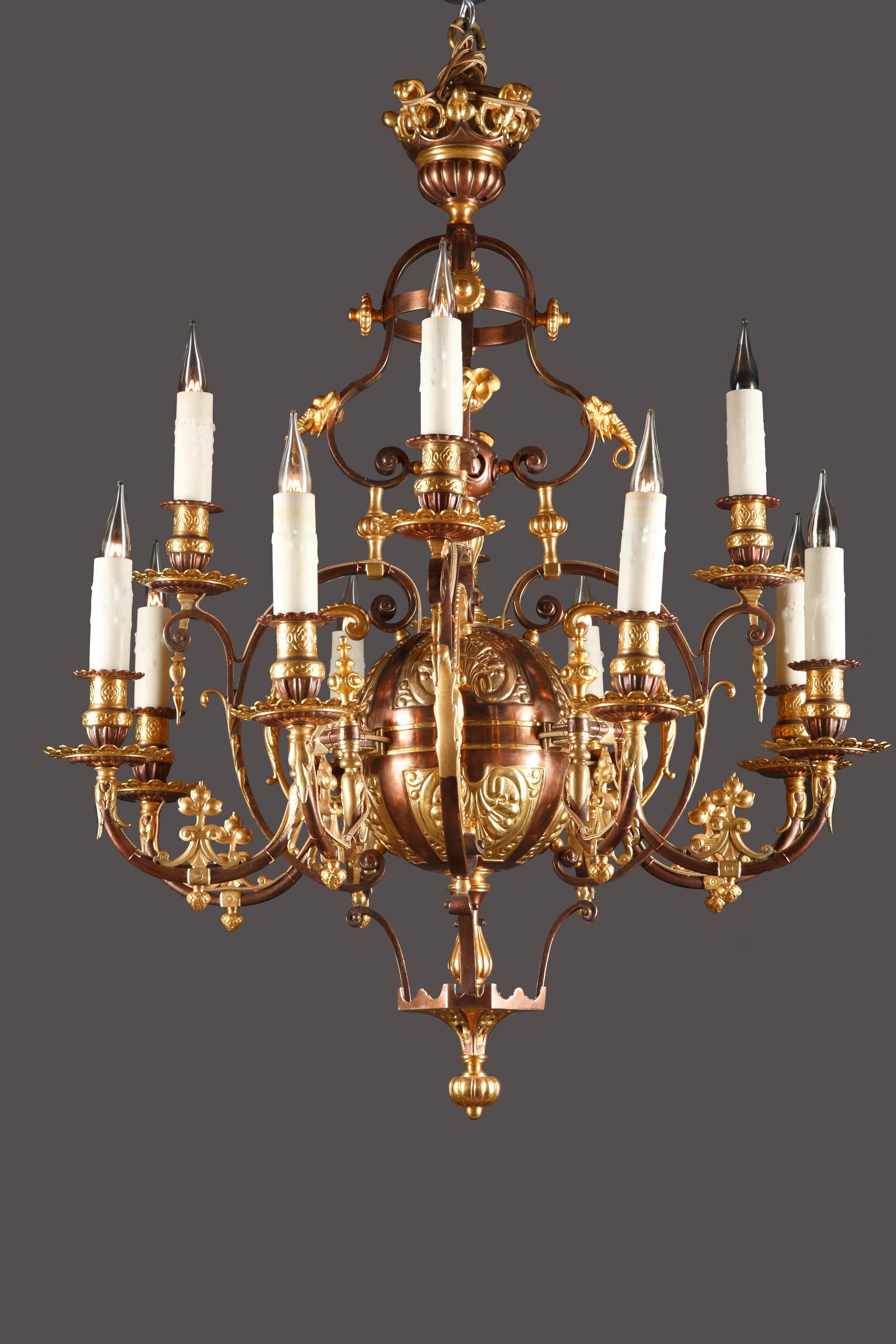 A very fine oriental style twelve light arms double patina bronze chandelier. With a beautiful bronze cast ornamented with fleur-de-lys, palmets and elephant heads cast in relief.