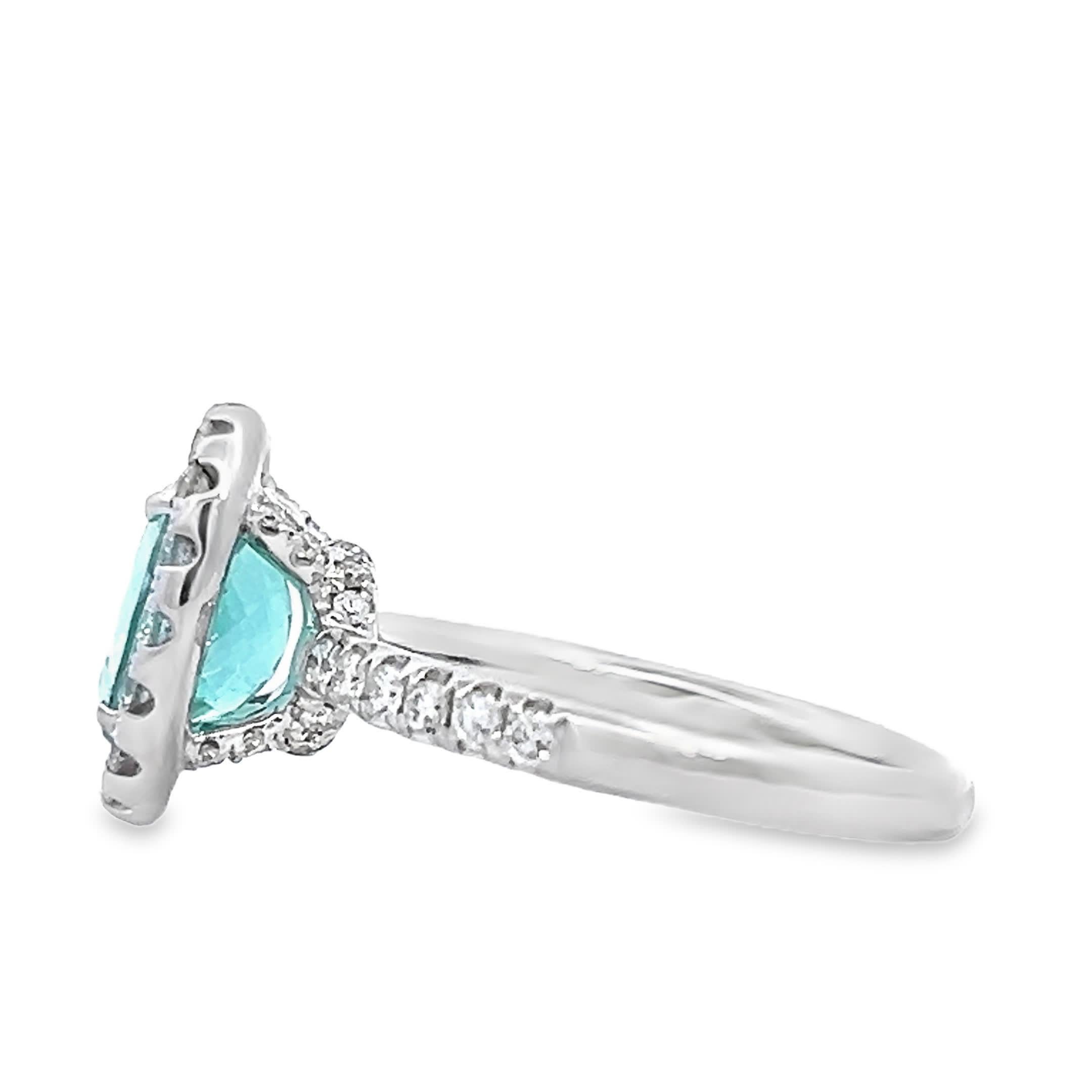 Discover the beauty of this elegant oval gemstone ring, featuring a stunning turquoise center stone surrounded by a halo of sparkling diamonds. Perfect for special occasions or as a statement piece in your everyday jewelry collection.