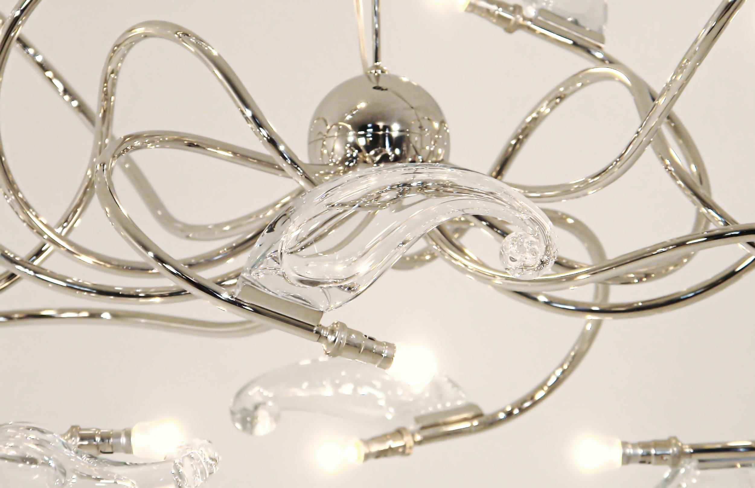 The glass curls are made in Bohemia, so every piece is a bit different. The lamp is approx 160x65 cm with 12 bulbs. Delivered with a hanging rod and ceiling plate in the same color.
