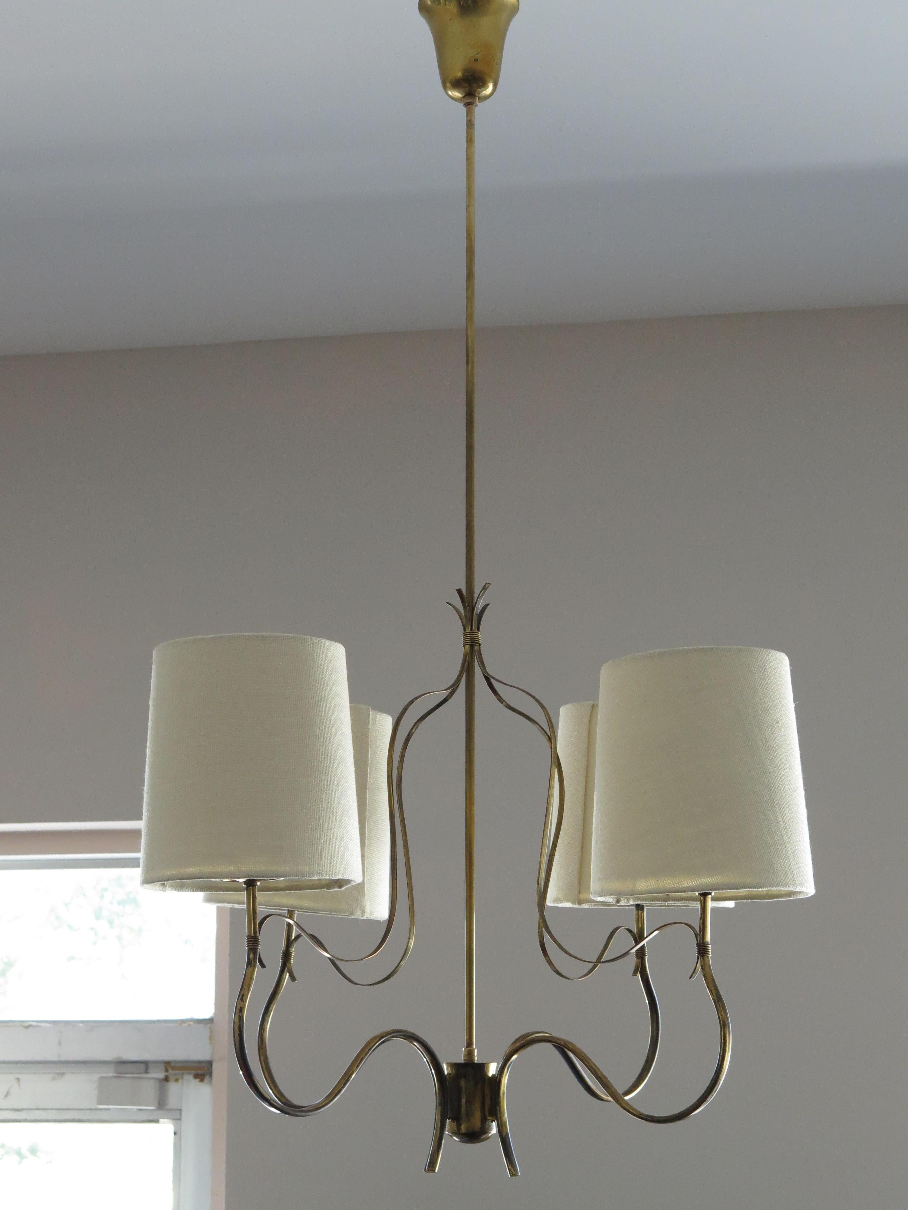Elegant and rare Paavo Tynell, Taito four arm chandelier. Model 9001/4. Includes custom made linen shades, original sockets, brass has patina and oxidation. Stamped Taito, polished/satin glass diffusers. Small scale-approx. 24