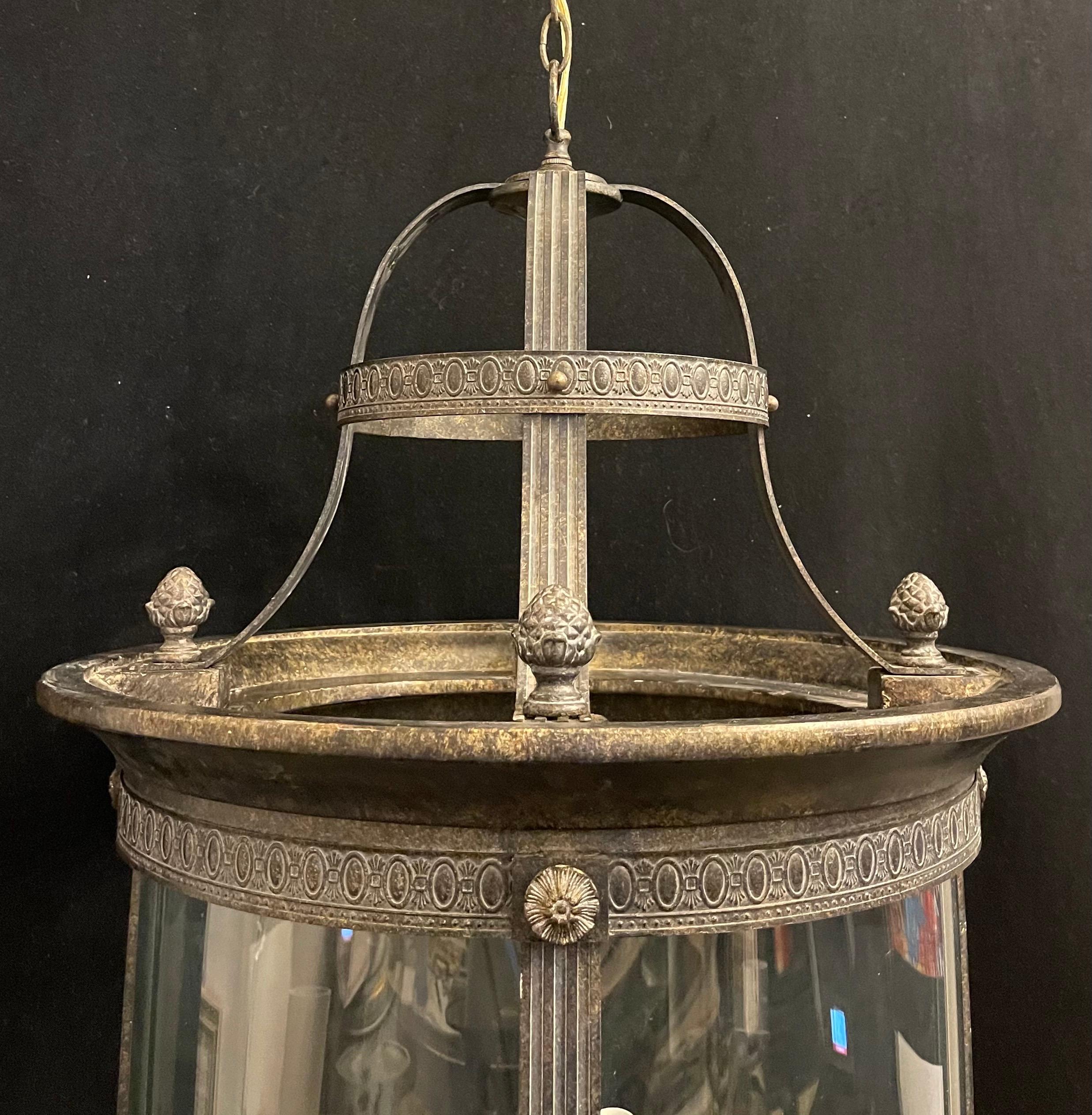 An elegant pair of large bronze gilt Louis XVI / neoclassical style 6 candelabra light fixtures each with 4 curved glass panels, both lanterns have been rewired and come with chain canopy and mounting hardware for installation.