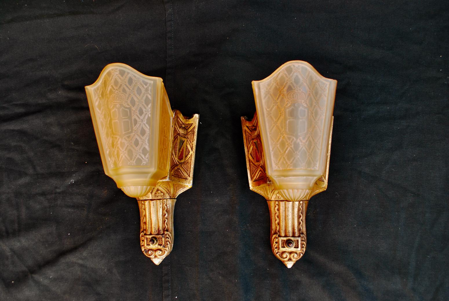 A beautiful pair of 1920s cast iron sconces, the patina is much nicer in person, the glass has a beautiful pattern, we are going to remove some of the white paint that is on the edge of the metal frame.