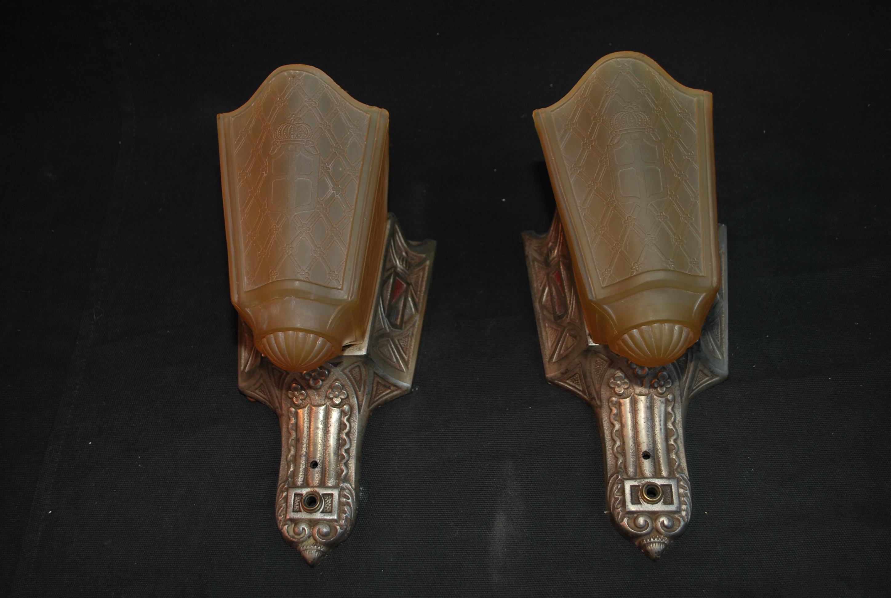 A beautiful pair of Art deco sconces, made of cast iron with a silver plated coating, they are made of qualities , the shades have beautiful  engraving
