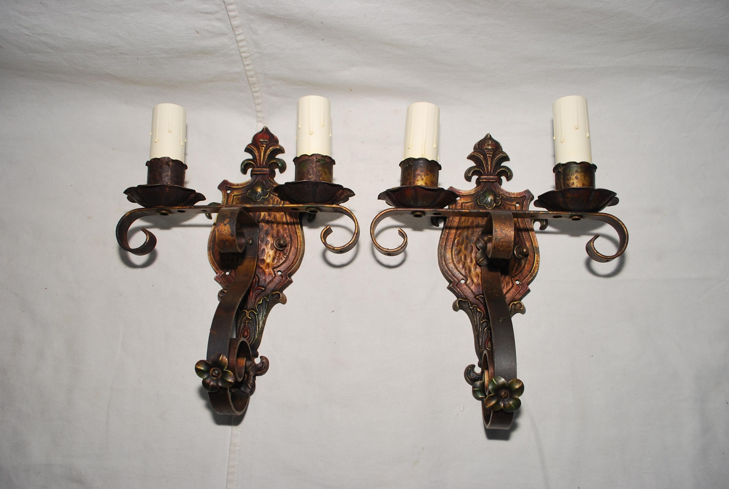 A beautiful pair of 1920's wrought iron sconces, BEWARE they are darker in person, the flash of the camera made them brighter, the patina is so much  nicer in person, they look more authentic in person 