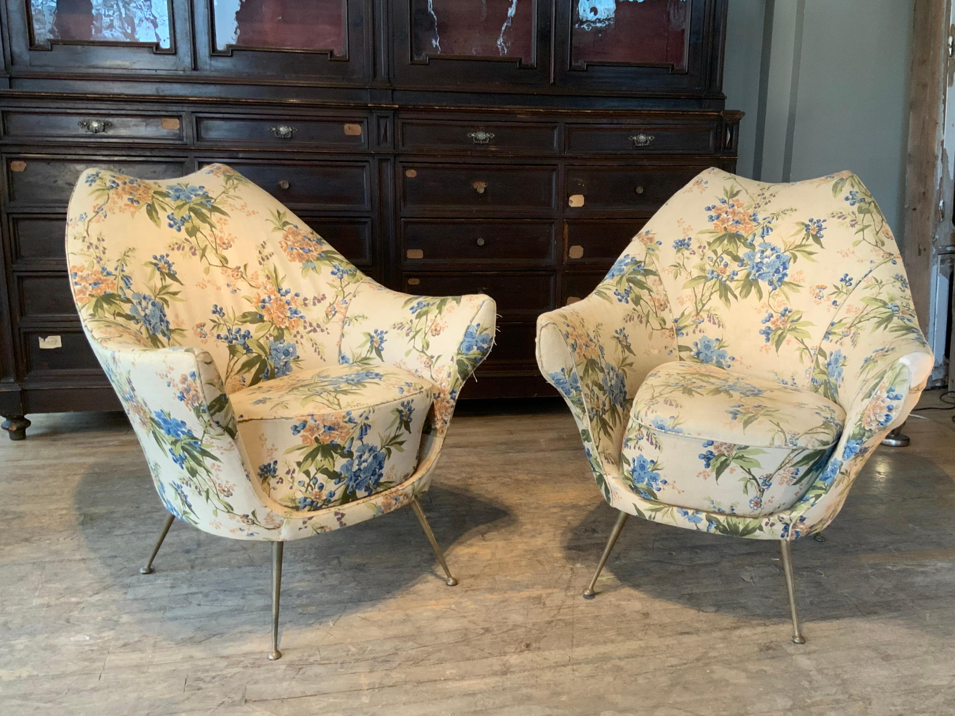 An incredibly beautiful pair of 1940's Italian lounge chairs, with curved arms and back, and raised on tall tapered brass legs. amazing design and proportions, and sexy from every angle! these are in their original 1940's Italian floral upholstery,