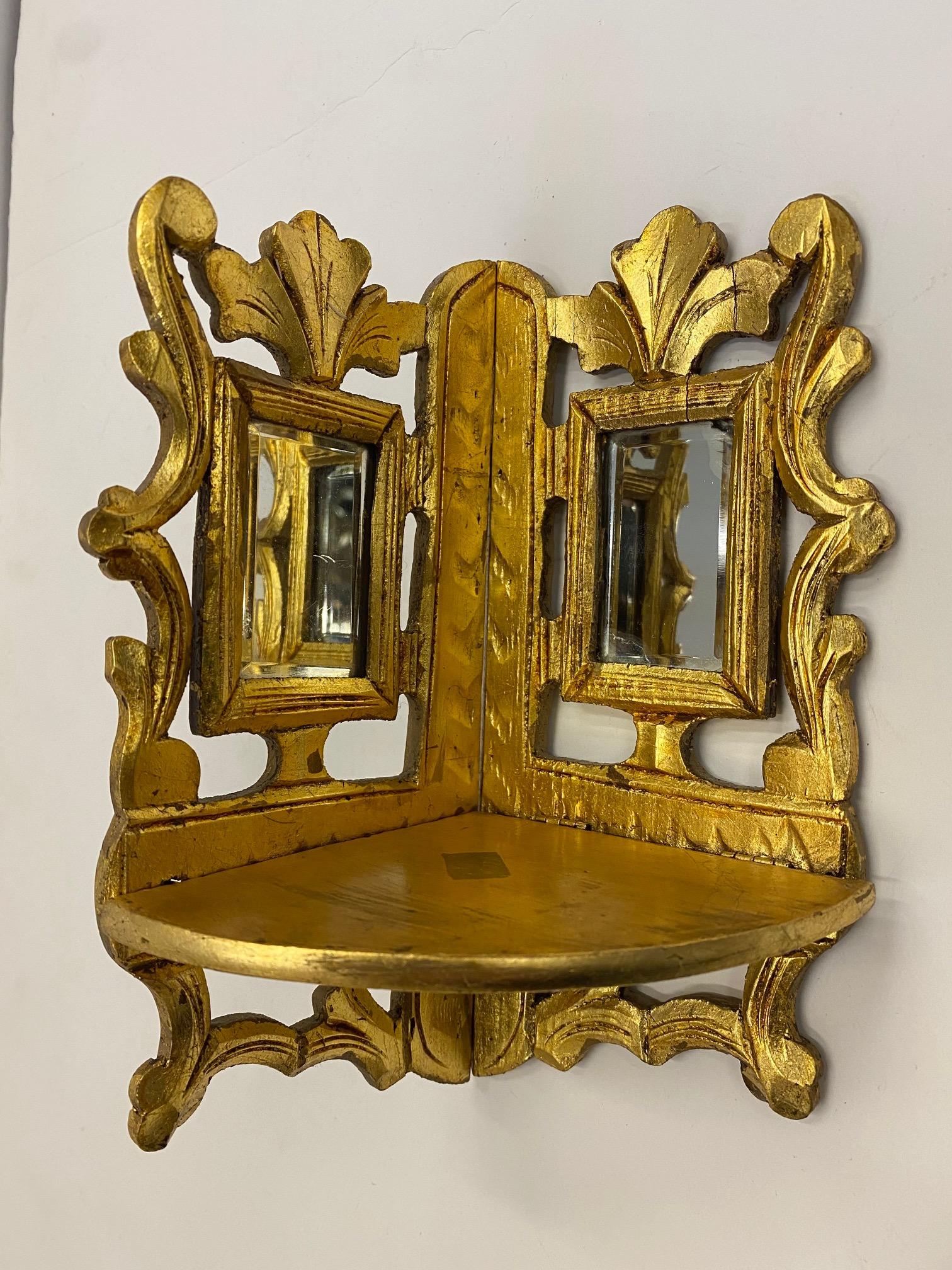 Unusual pair of antique carved giltwood corner brackets with lovely mirror insets.