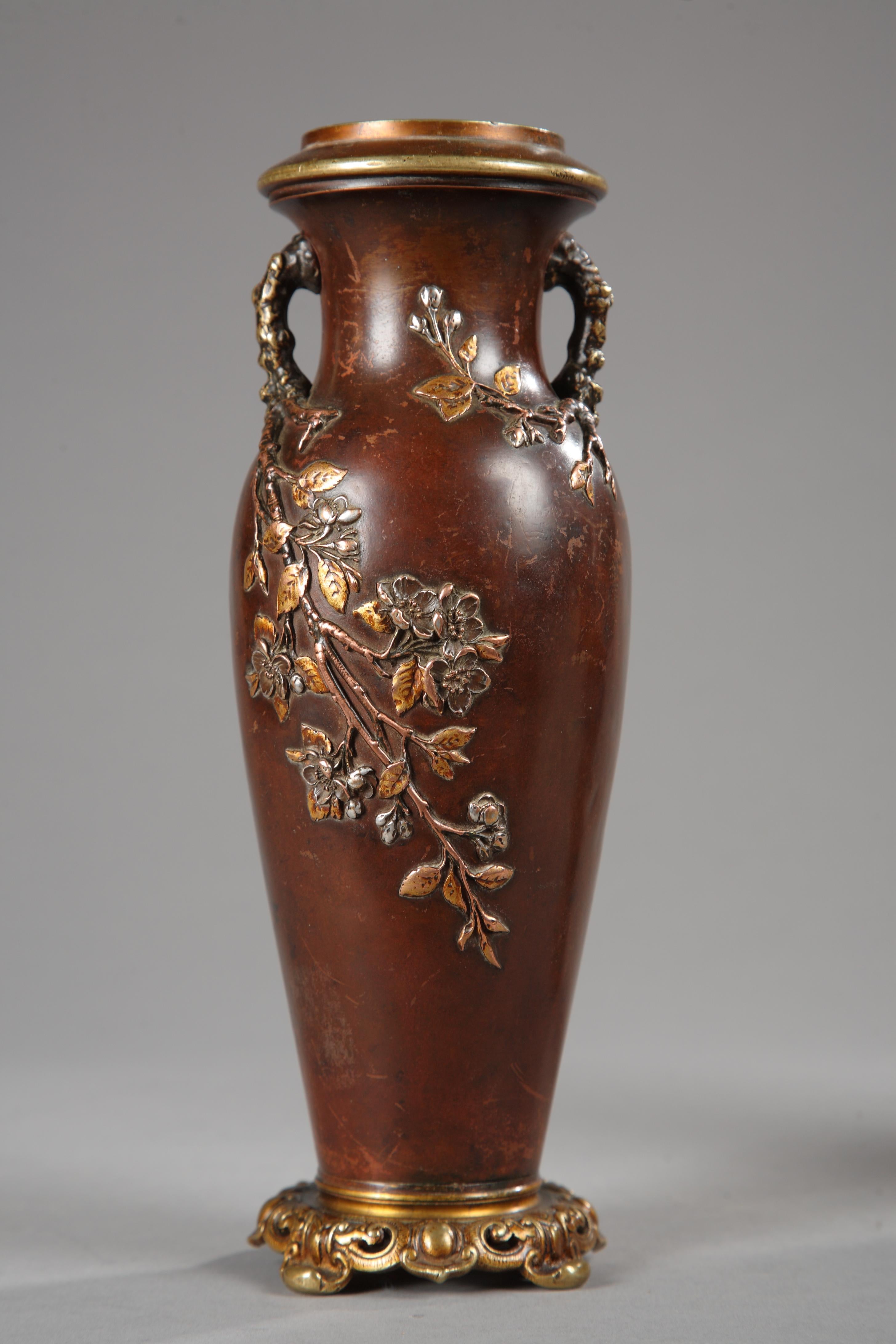 A very fine pair of Japanese style vases attributed to Susse Frères and made in two patina bronze. Each vase in form of a patinated bronze ovoid body, subtly ornated in gilded relief with blossoming Japanese cherry tree branches laid out in spiral,