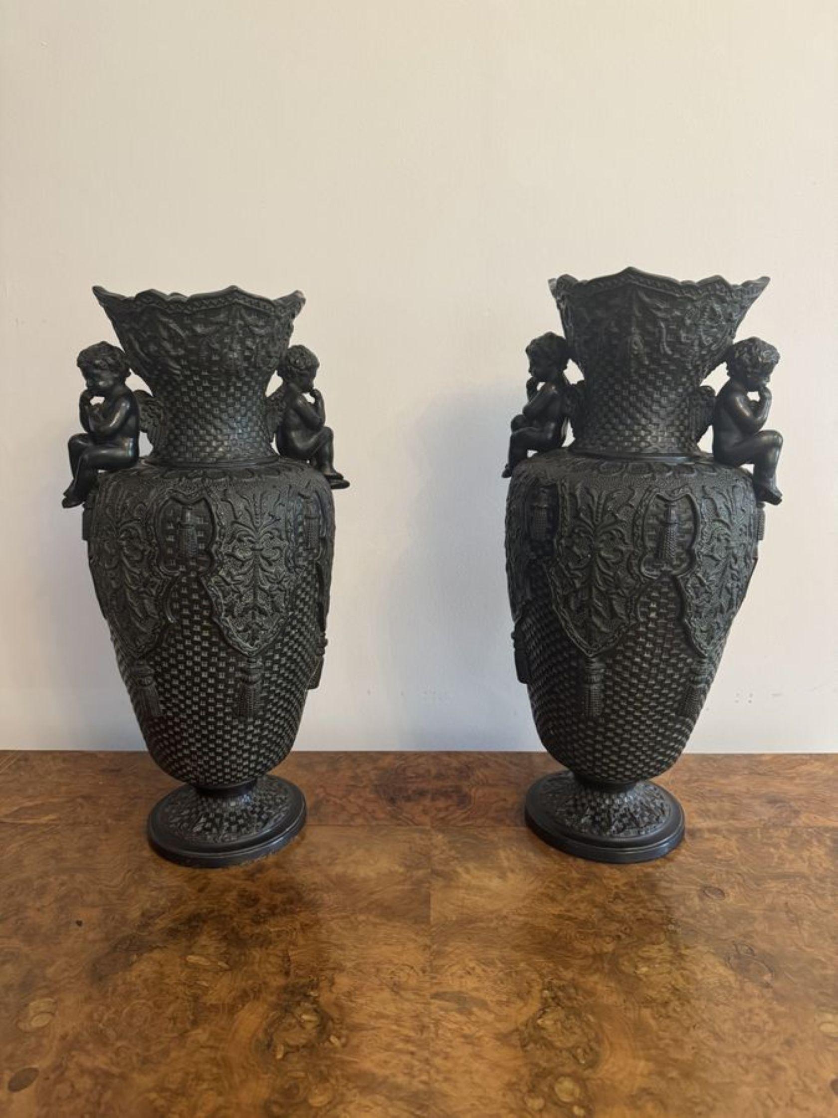 Elegant pair of antique Victorian vases by Bernhard Bloch, having a beautiful pair of urn shaped vases with a pair of cherubs to the neck of the vase in a seated position, raised on circular shaped bases.
Stamped to base a shown. 

D. 1890