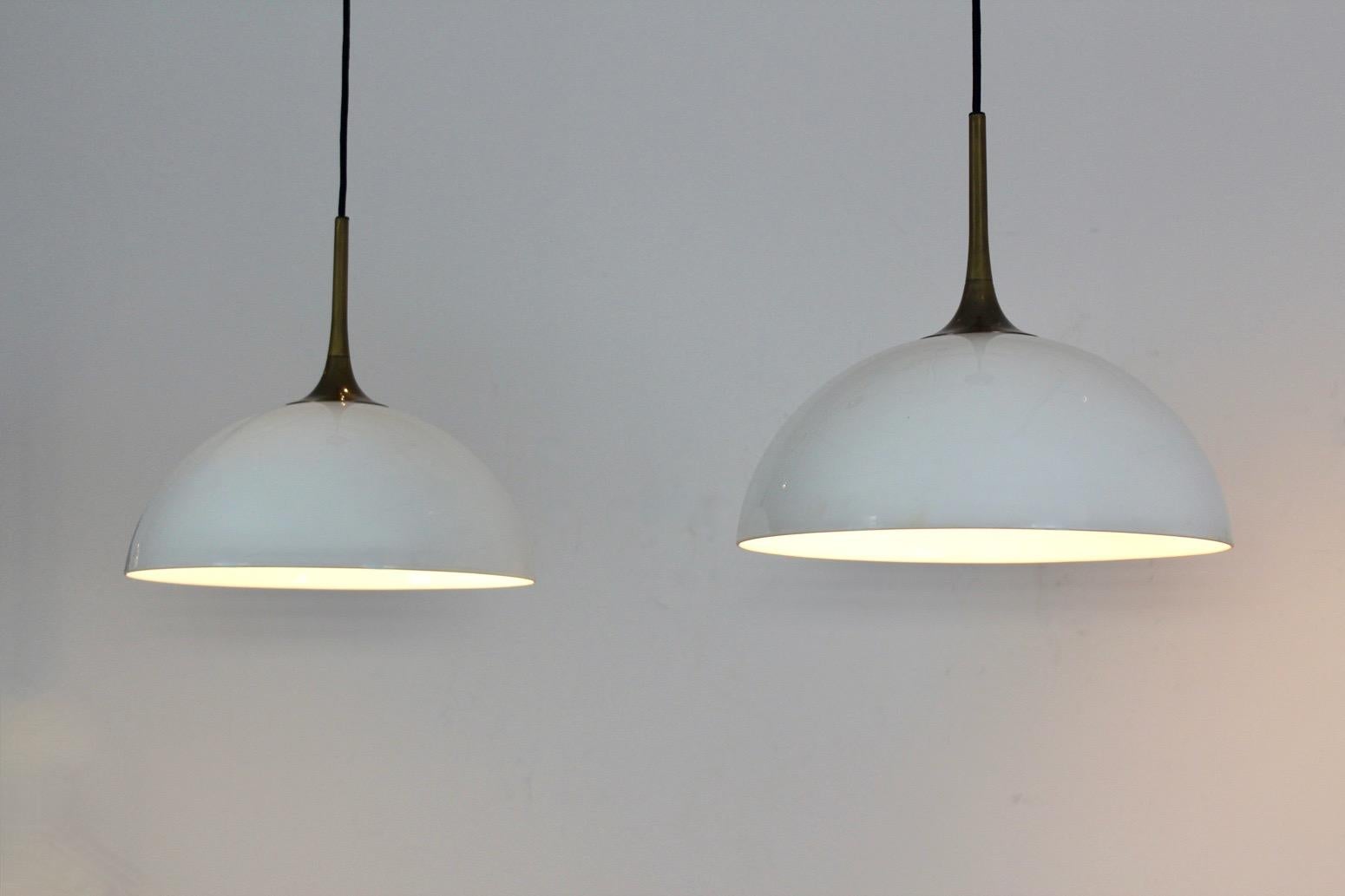 Pair of rare and wonderful solid brass and blown glass white-opal pendant lights by Florian Schulz, Germany. The pendant lamps are incredibly well made and very versatile because the height is adjustable as the length of the wire is 2 meters. The