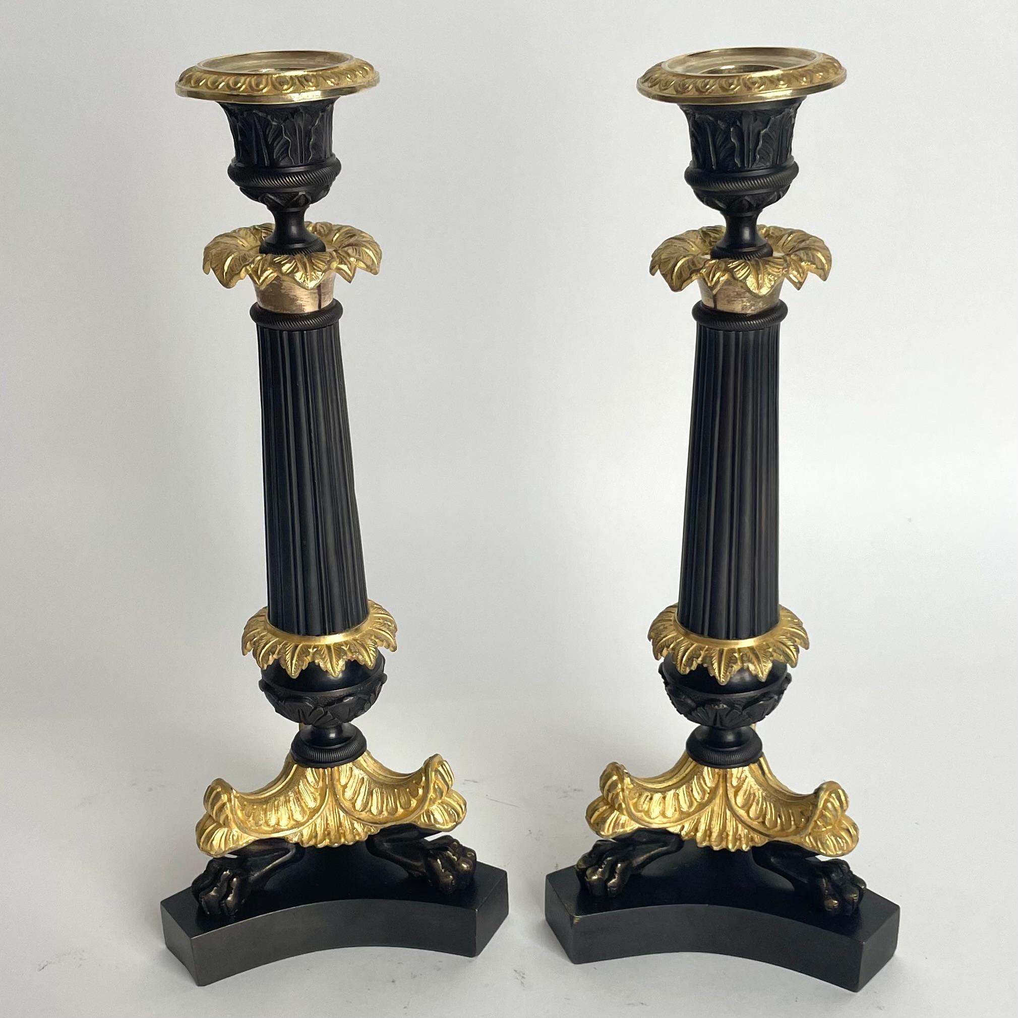 A very Elegant pair of Candlesticks in Louis Philippe. France during the 1830s. The dark patinated and gilded bronze brings a very sophisticated contrast.

Wear consistent with age and use 
