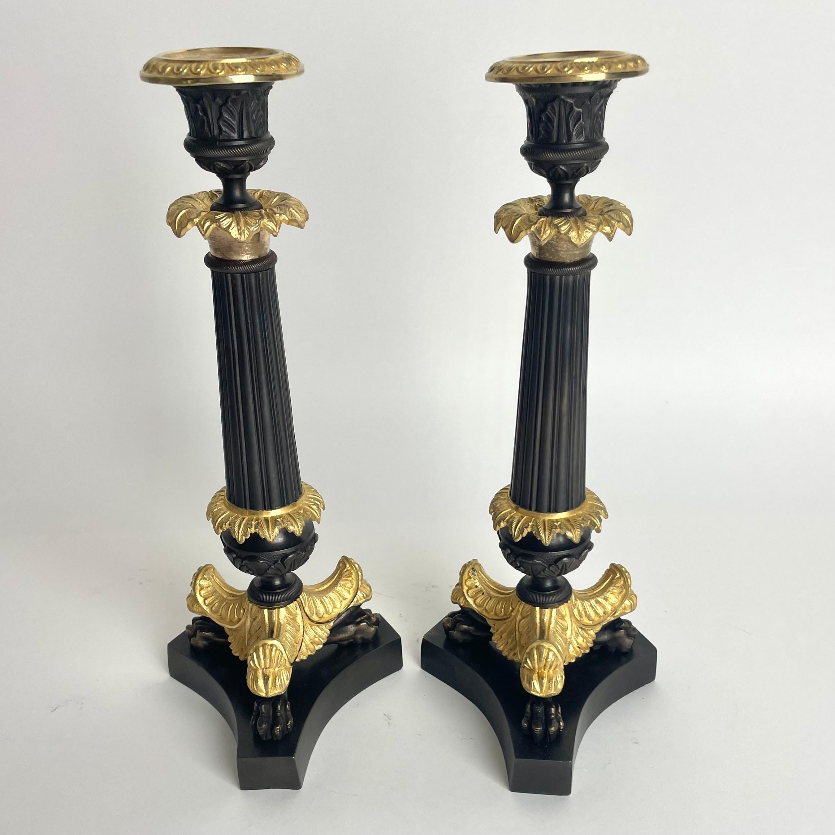 Gilt Elegant pair of Candlesticks in Louis Philippe. Dark patinated and gilded bronze For Sale