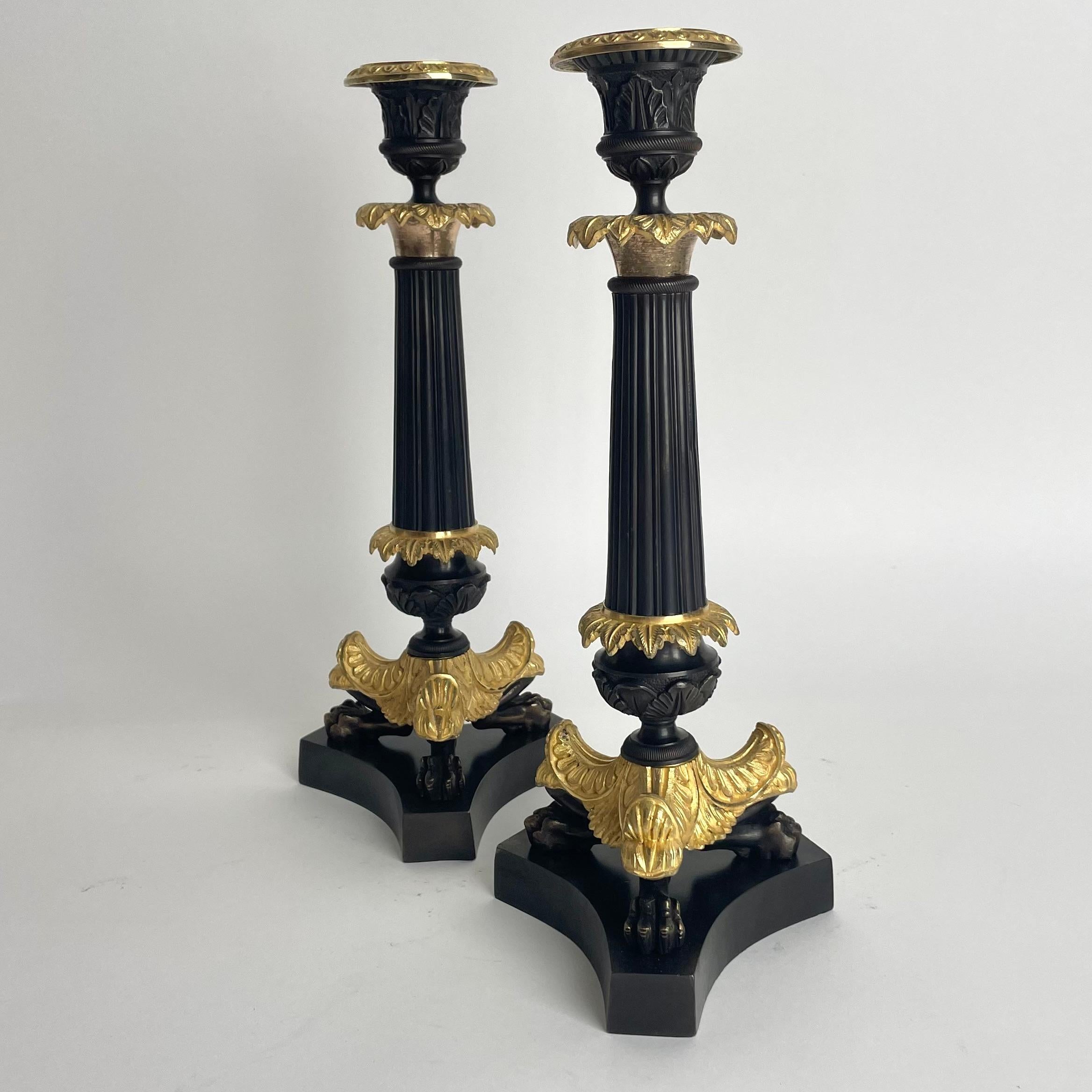 Elegant pair of Candlesticks in Louis Philippe. Dark patinated and gilded bronze In Good Condition For Sale In Knivsta, SE