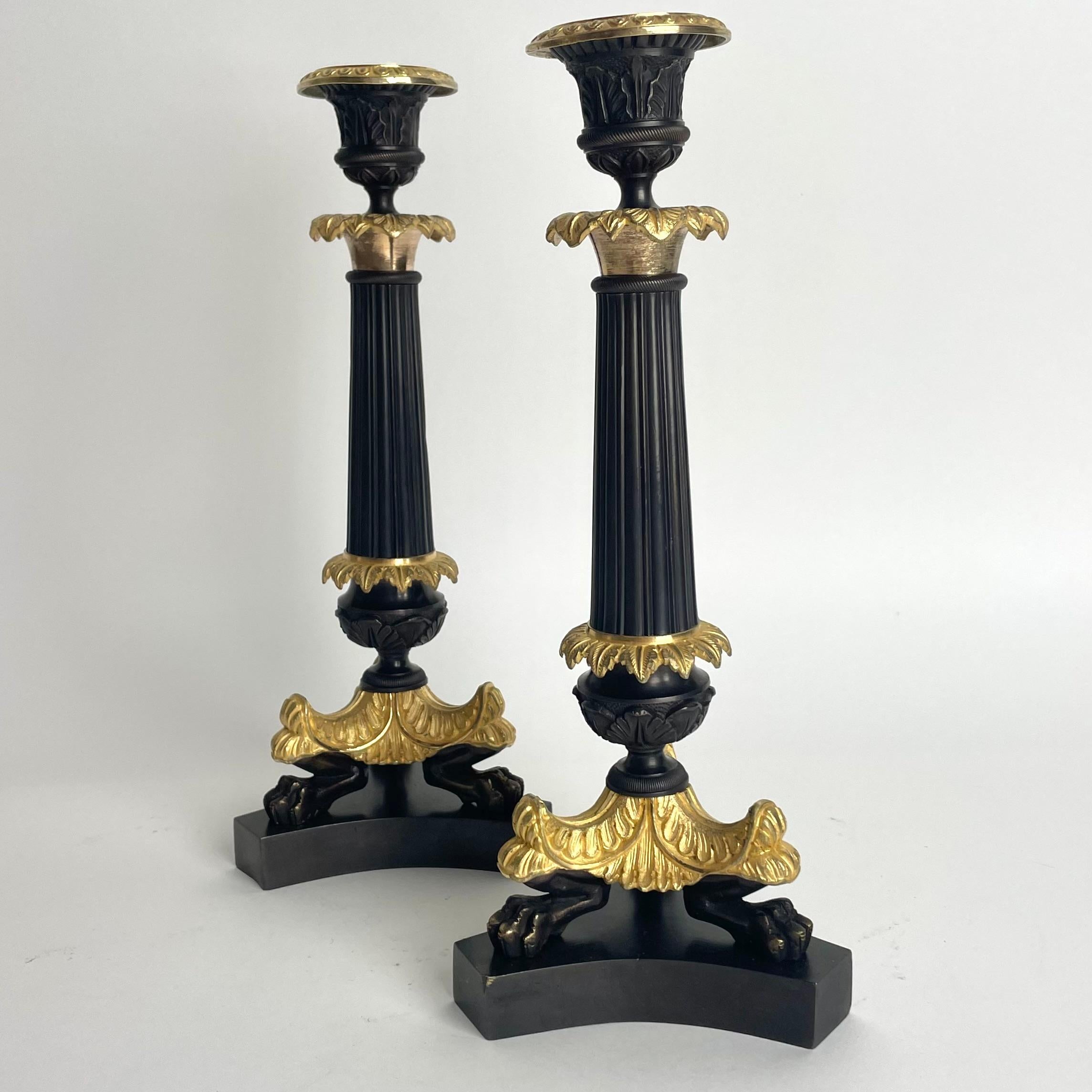 Bronze Elegant pair of Candlesticks in Louis Philippe. Dark patinated and gilded bronze For Sale