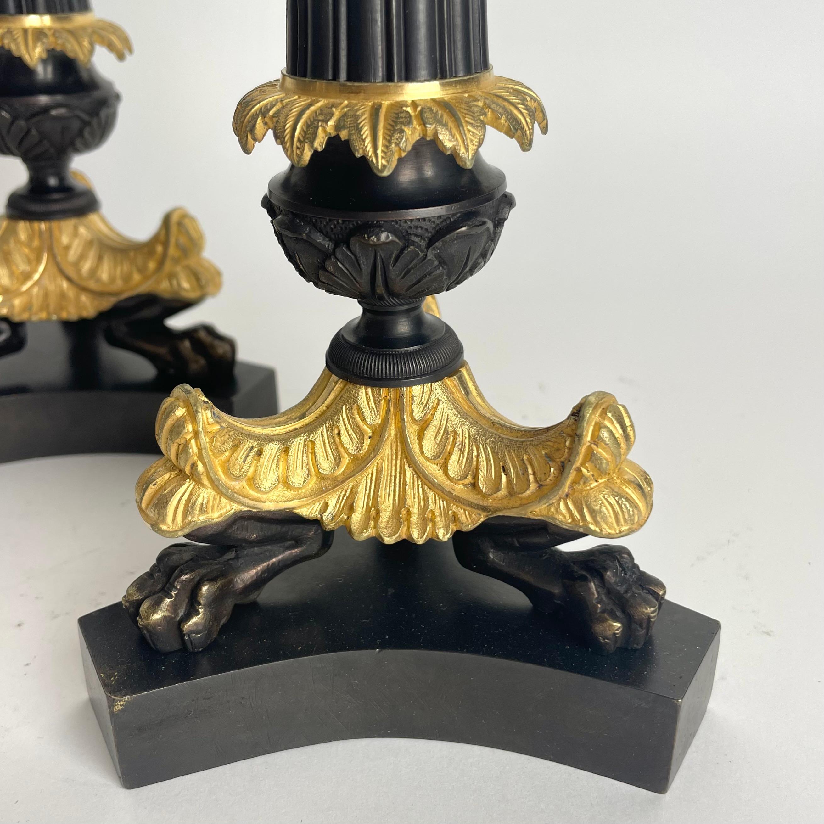 Elegant pair of Candlesticks in Louis Philippe. Dark patinated and gilded bronze For Sale 1