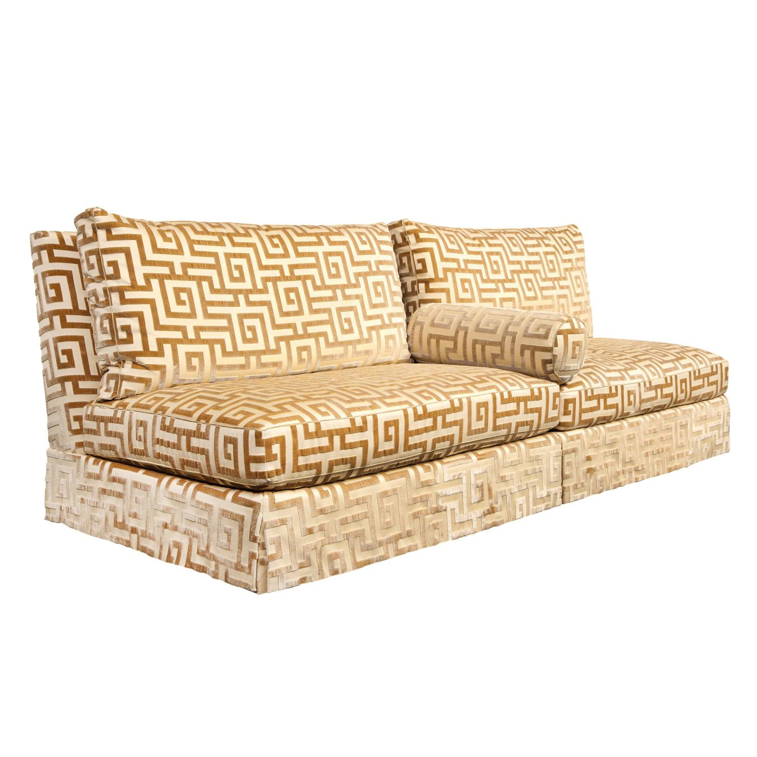 Pair of custom matching armless sofas in luxurious gold Greek key sheared velvet by a NYC designer, American 1990's. Can be used with or without the round arm pillows. These are in like-new condition and beautifully made.

Provenance:
Made for a