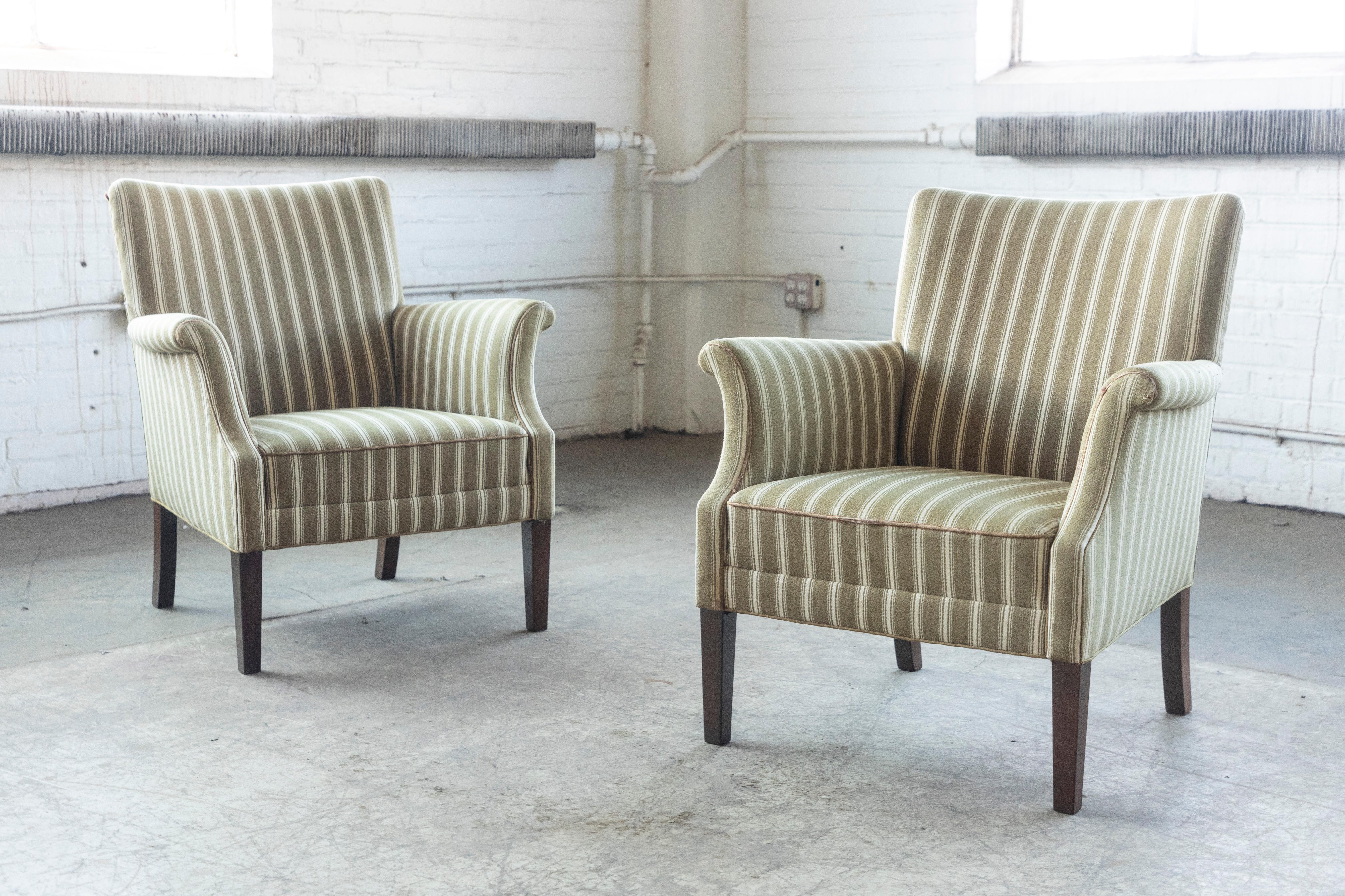 Beautiful pair of 1950s Danish easy chair attributed to Fritz Hansen. Very elegant with their distinct shape, precise lines and harmonious proportions. Very versatile size well suited for today's urban homes. The chairs have been reupholstered at a