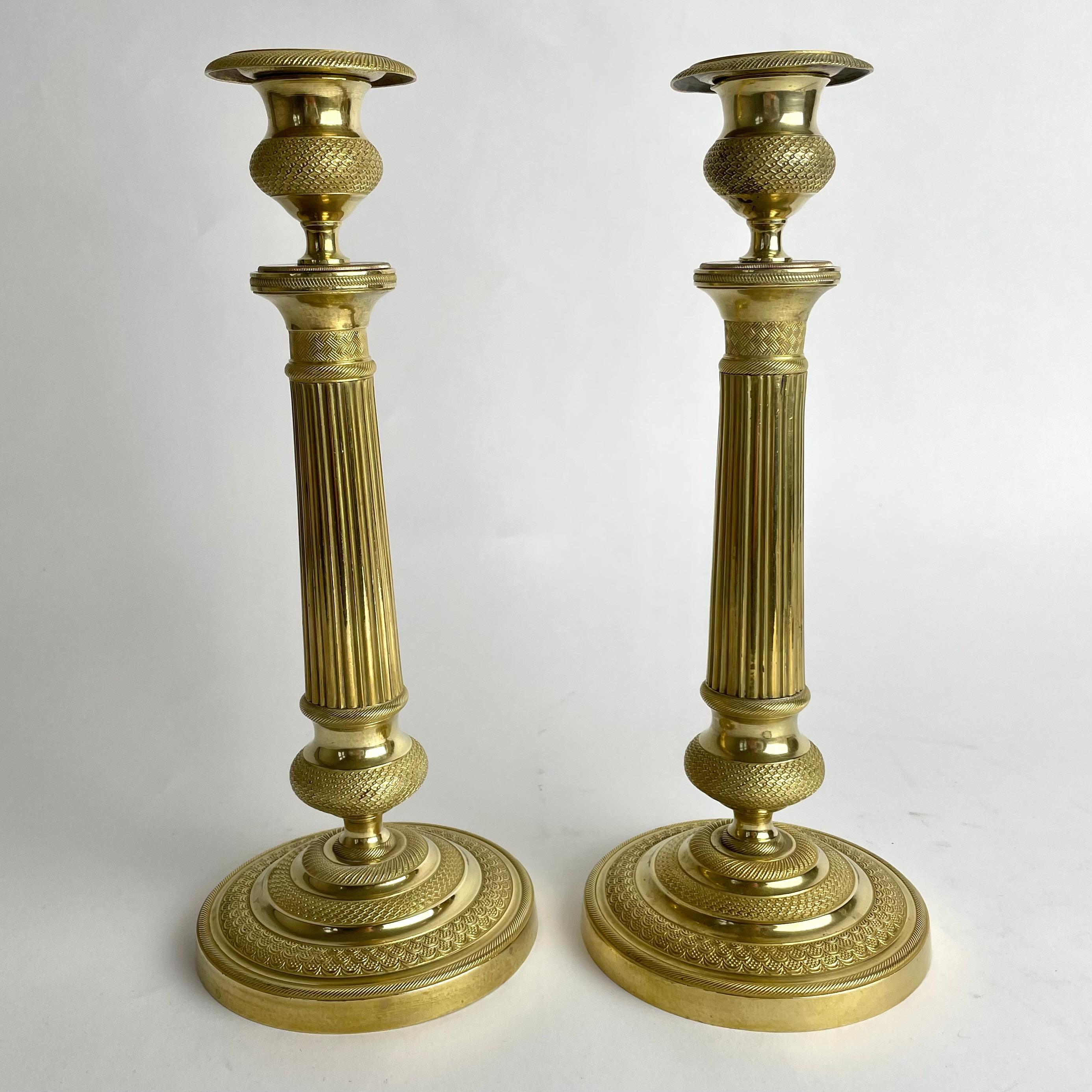 French Elegant pair of Empire Candlesticks in gilt bronze from the 1820s.  For Sale