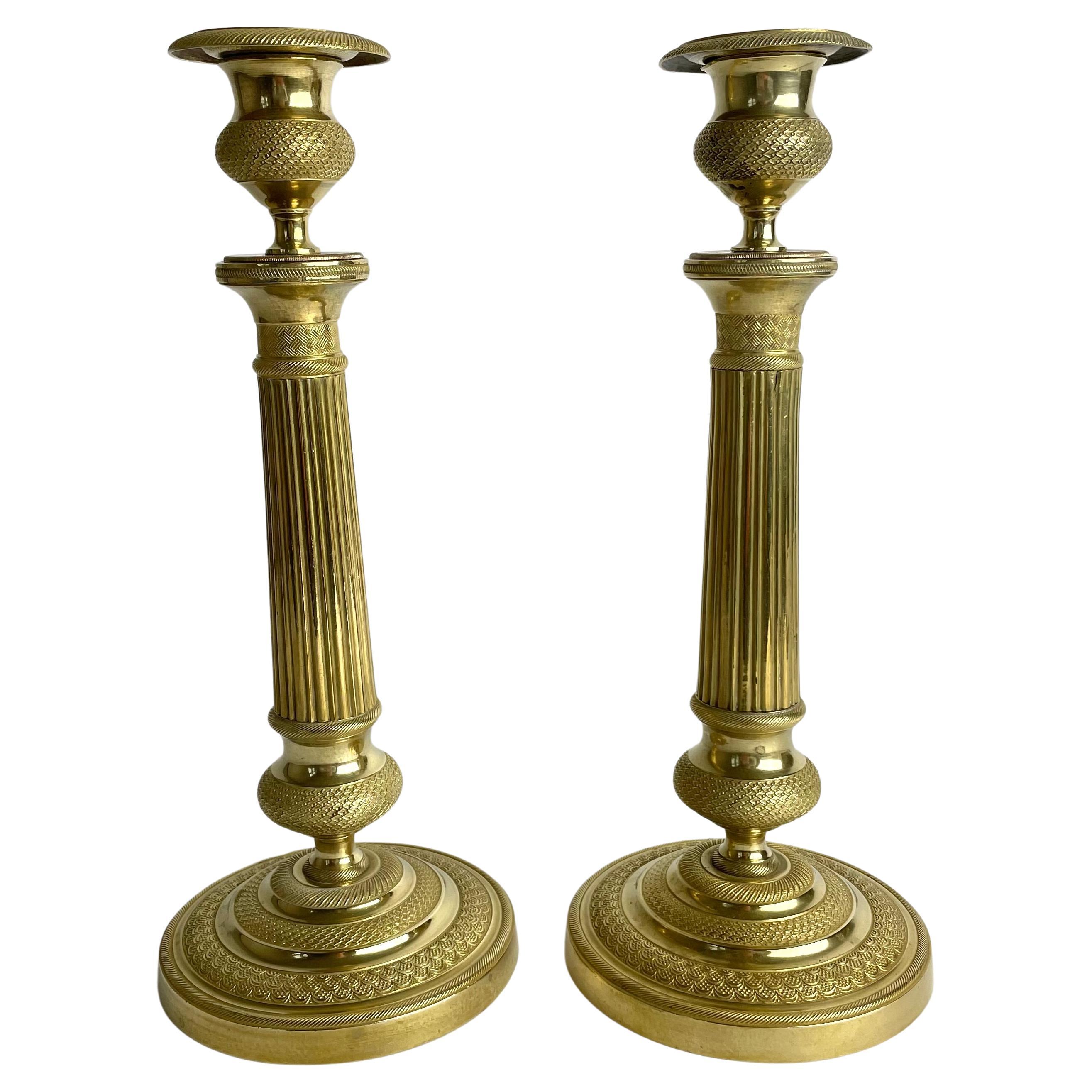 Elegant pair of Empire Candlesticks in gilt bronze from the 1820s.  For Sale