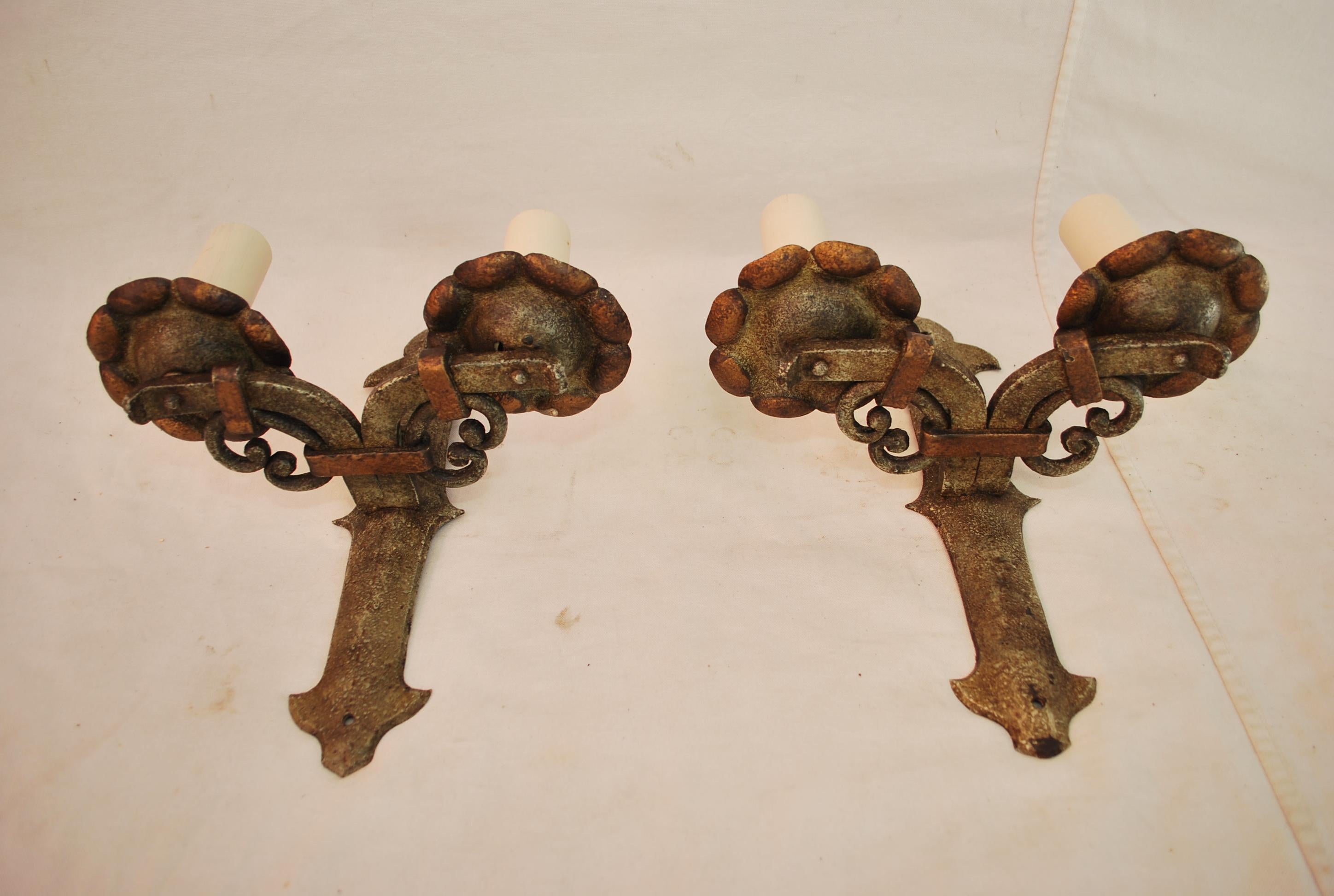 A beautiful pair of French 1920's hall hands forged wrought iron sconces, the patina is so much nicer in person, it is hard to catch the true beauty and patina with a digital camera.