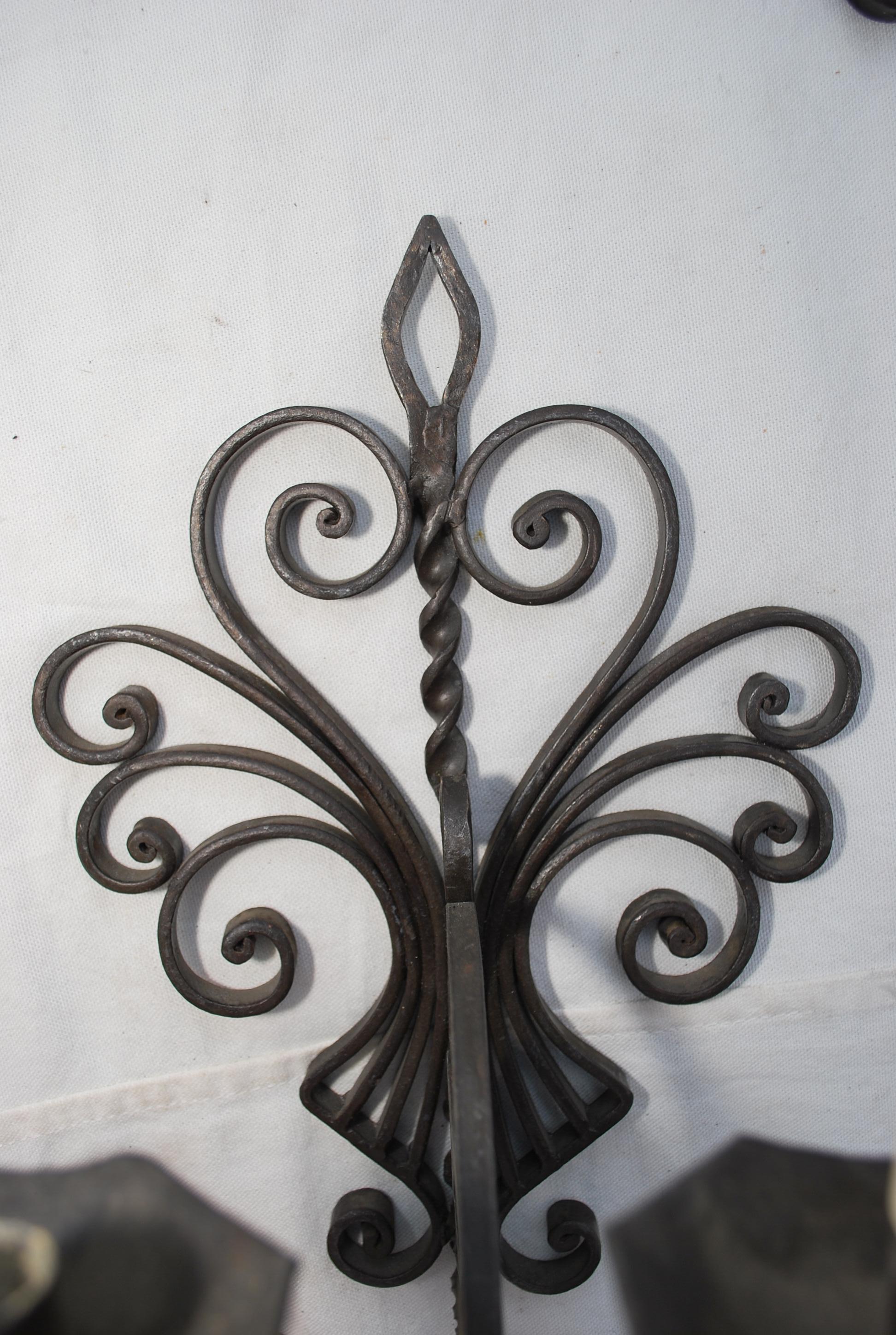 An elegant pair of wrought iron sconces, the patina is so much nicer in person, these sconces are black, the flash of the camera kind of distorted  the true color of the metal