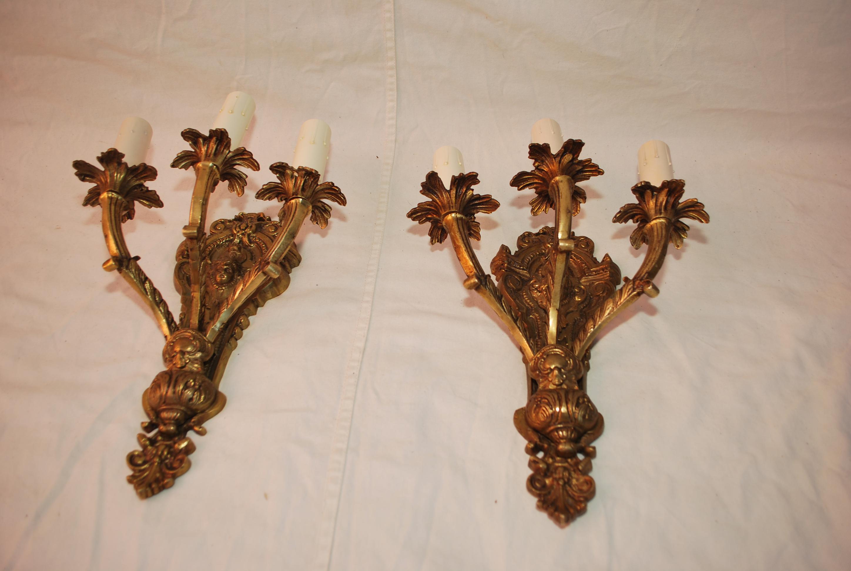 Elegant pair of French 1940's Brass sconces with cupids For Sale 2