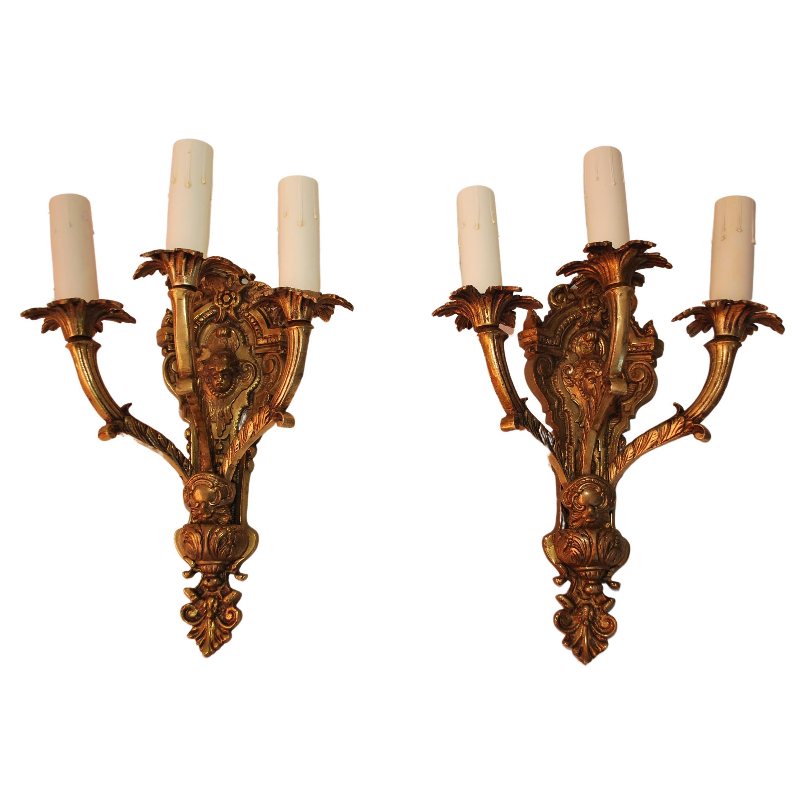 Elegant pair of French 1940's Brass sconces with cupids For Sale