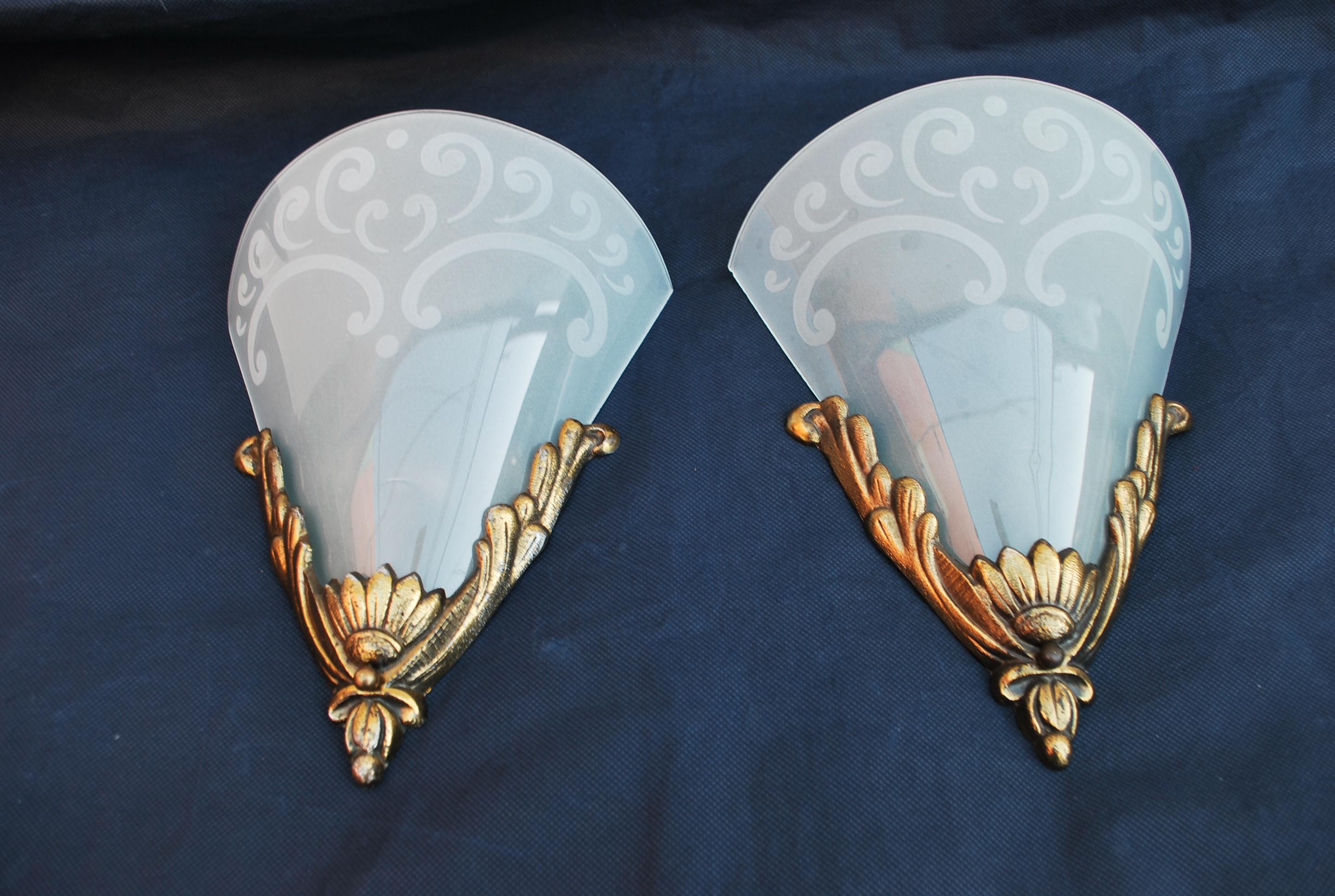 A beautiful pair of French Art Deco sconces, BEWARE THE GLASS IS A LITTLE MORE FROSTED AND WHITE,  it is because they were taken on a dark blue fabric, on a white fabric they look horrible, you could hardly see the glass