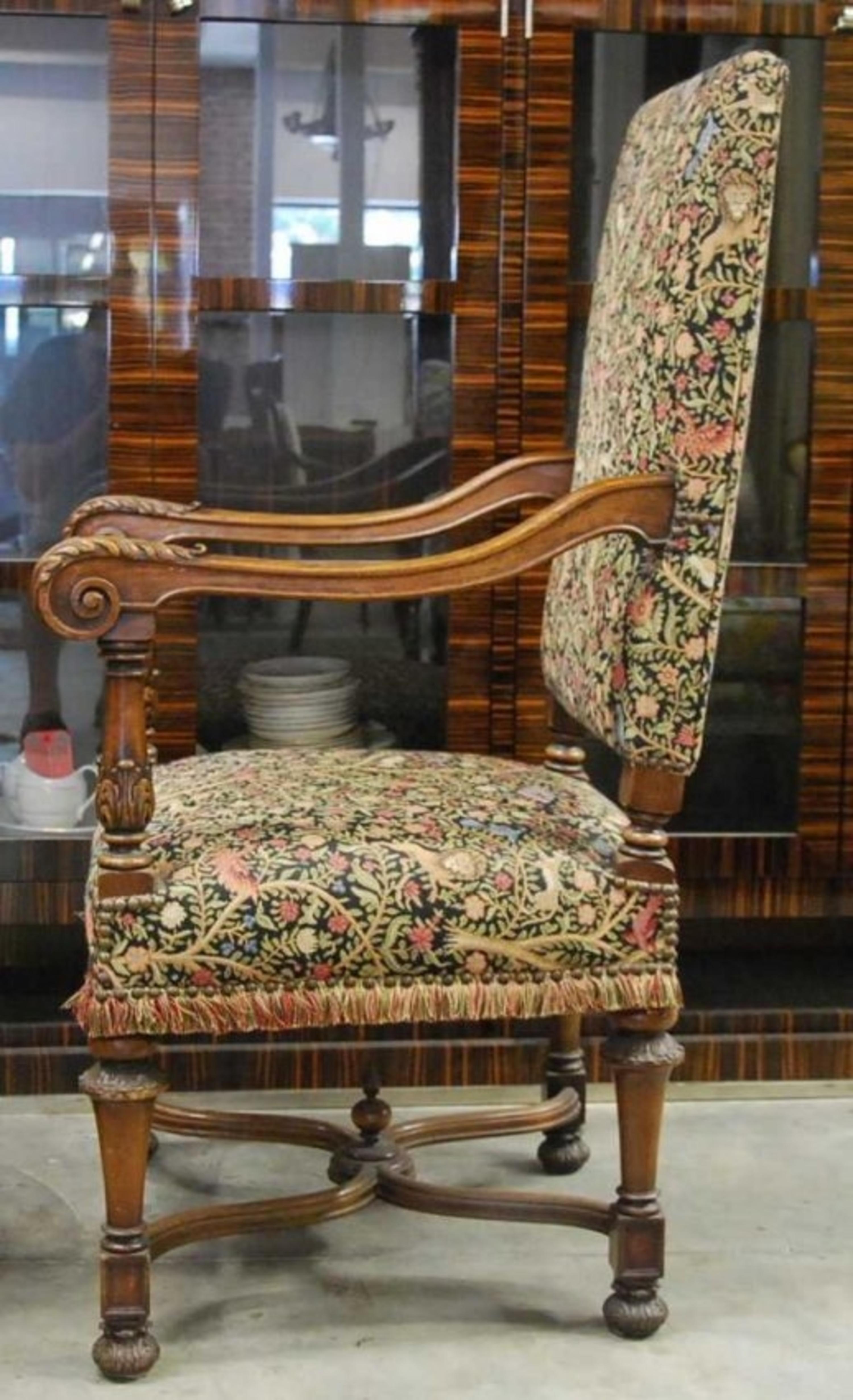 A pair of French Baroque style carved walnut fauteuils with tapestry fabric covers, 
late 19th century
Each with a upholstered back and seat, the arms with square incurved supports carved with husks and rising acanthus leaves and with scrolled