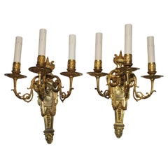 Elegant pair of French bronze sconces