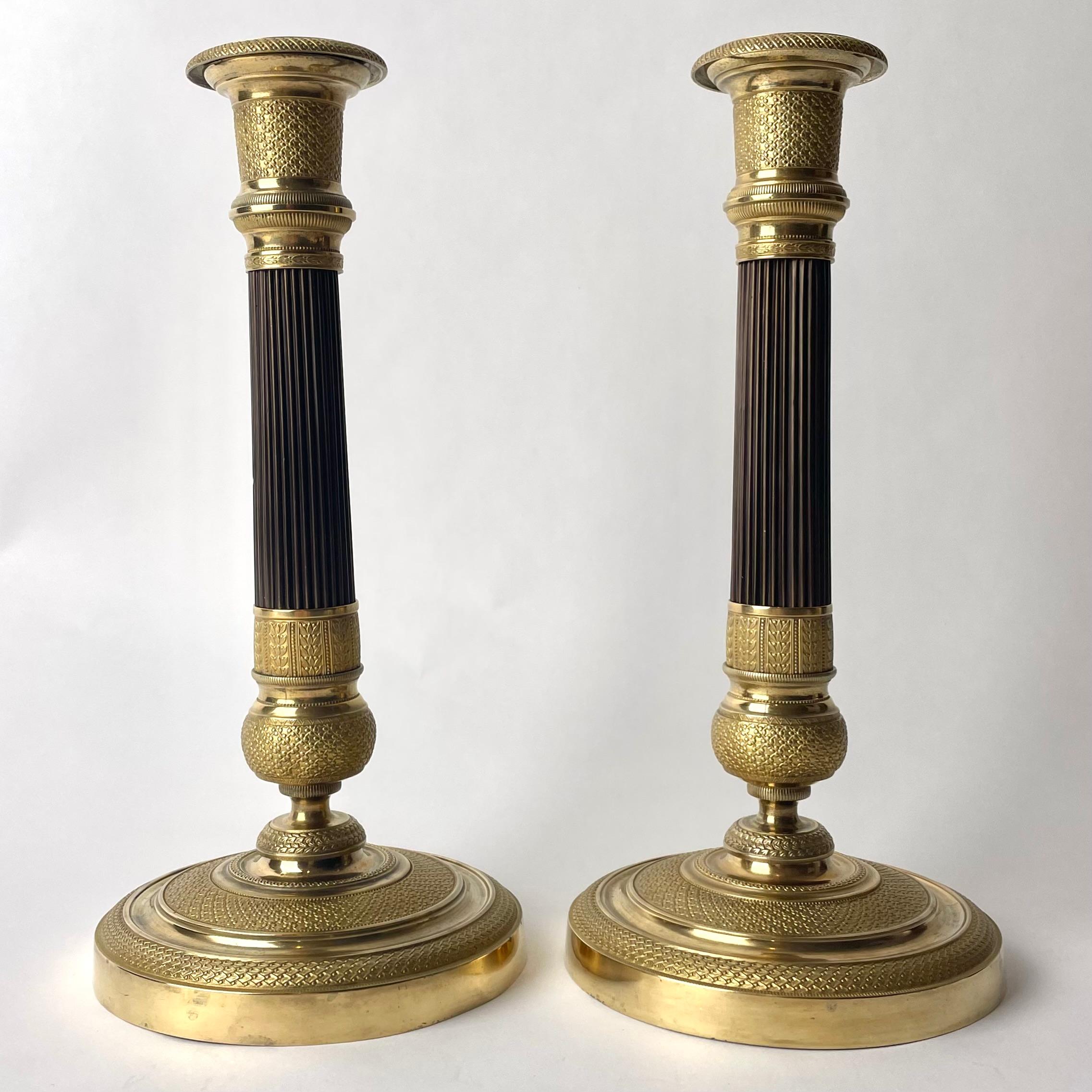Very elegant pair of French Empire gilt and dark patinated Bronze Candlesticks. Probably made in Paris during the 1820s. Richly decorated in period Empire and with a dark patinated column.


Wear consistent with age and use 